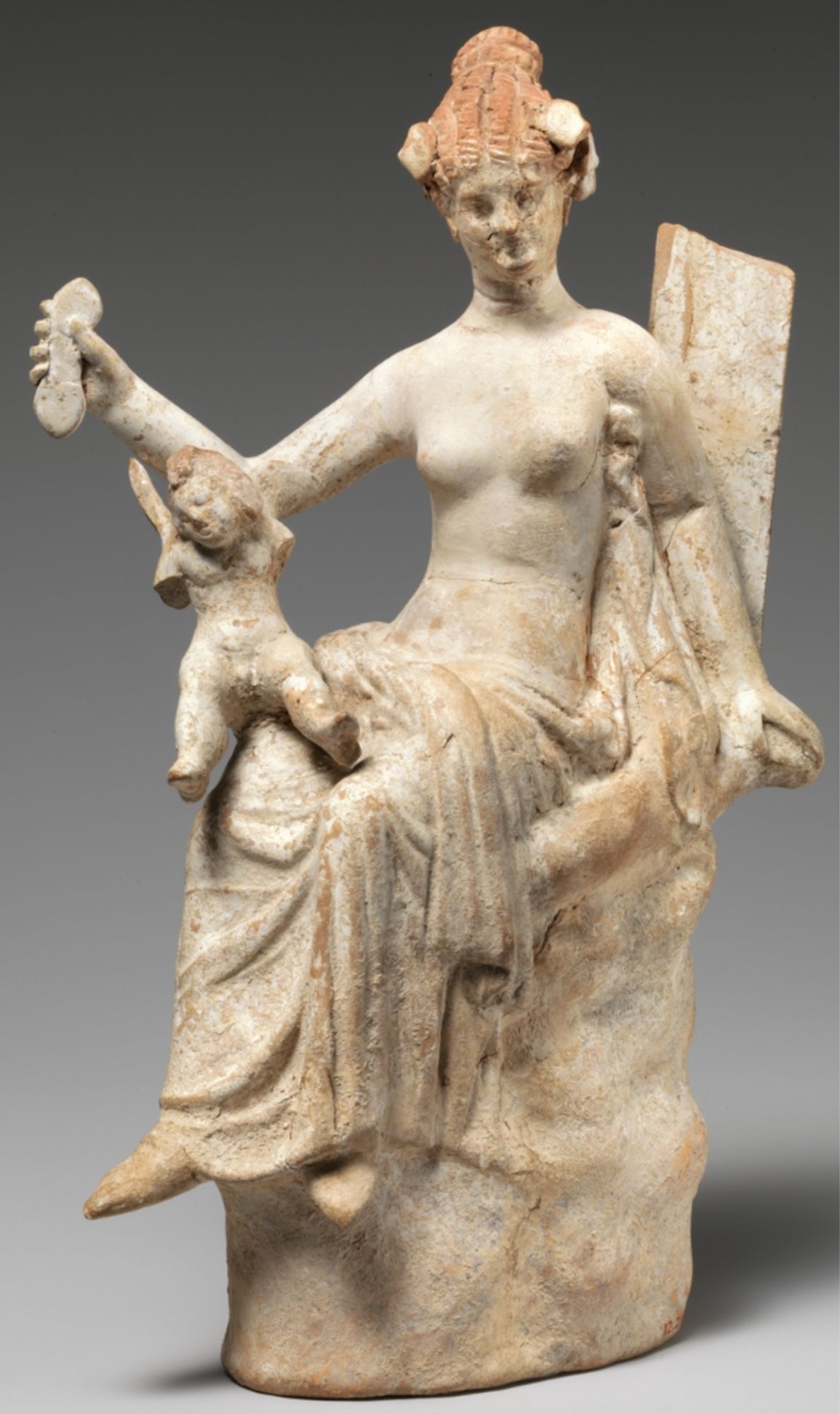 Terracotta statuette of Aphrodite and Eros
Greek, South Italian
3rd century BCE
 On view at The Met Fifth Avenue in Gallery 164

In Greek mythology, Eros is the son of the goddess Aphrodite and her lover Ares, god of war. Images of Aphrodite and the baby Eros together became popular in the Hellenistic period as never before, a trend that was also reflected in literature of the time.