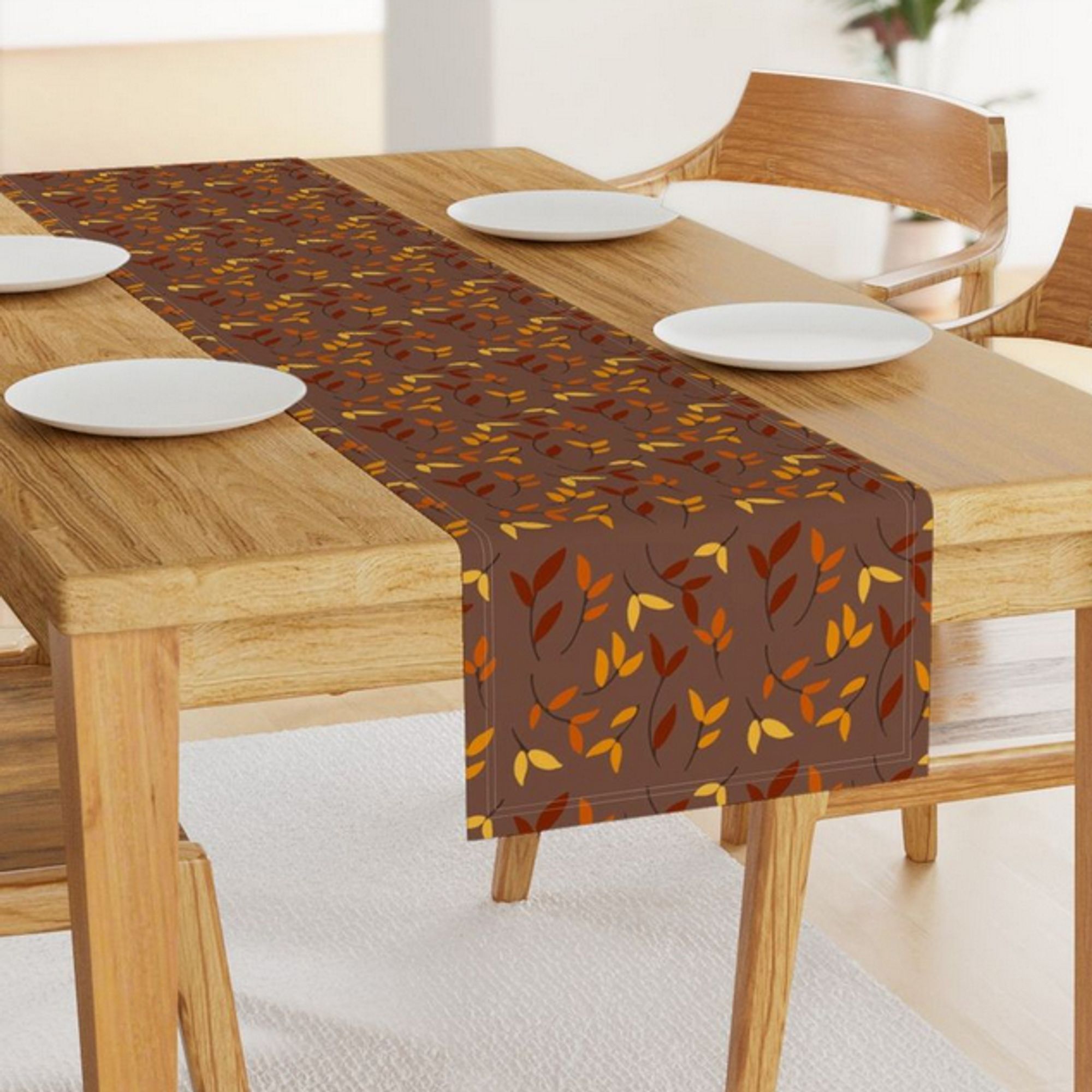 A falling leaf surface pattern design in Autumnal colors on a table runner.