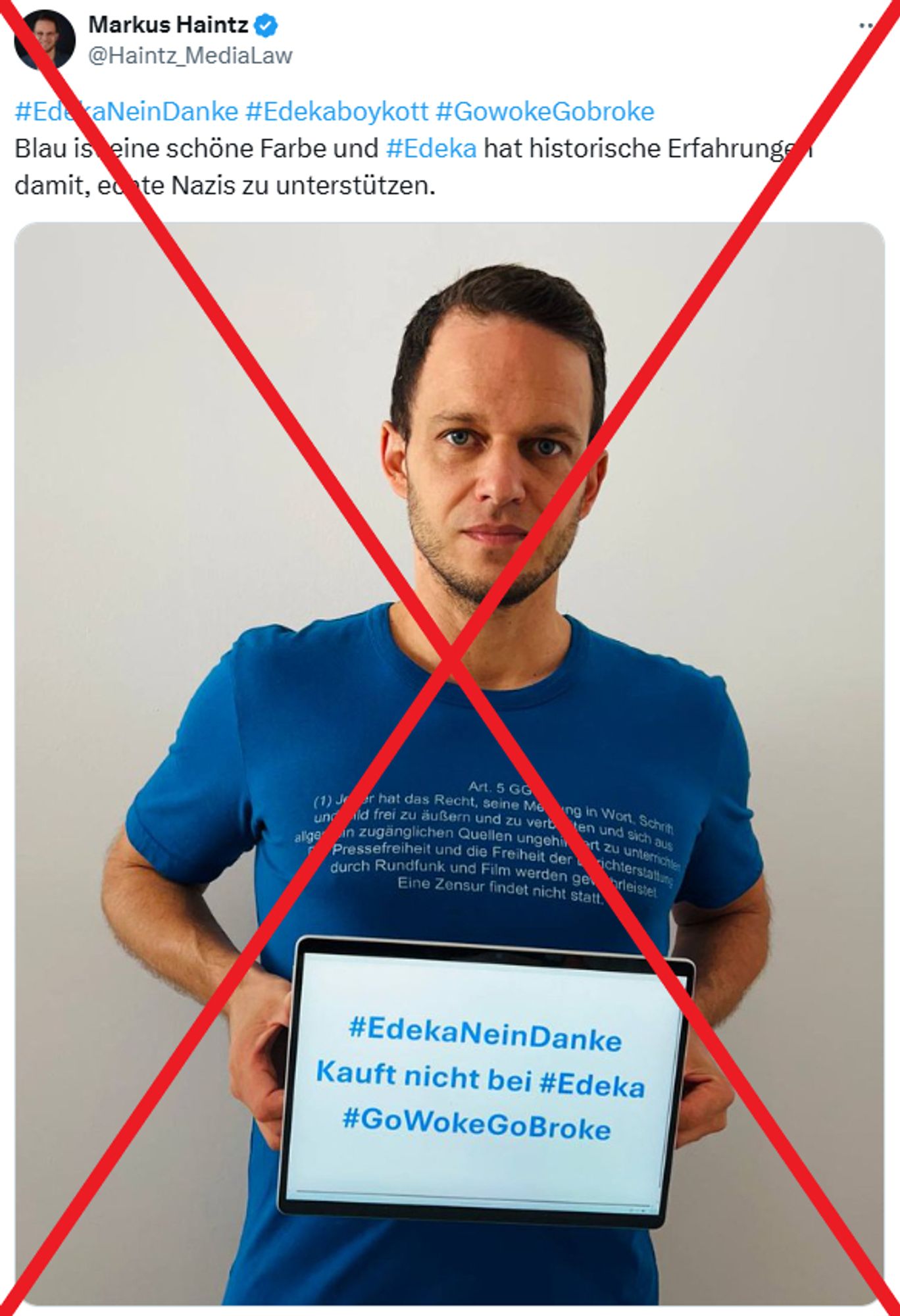 Markus Haintz hält ein Schild vor den Bauch mit der Aufschrift:

#EdekaNeinDanke
Kauft nicht bei #Edeka
#GoWokeGoBroke