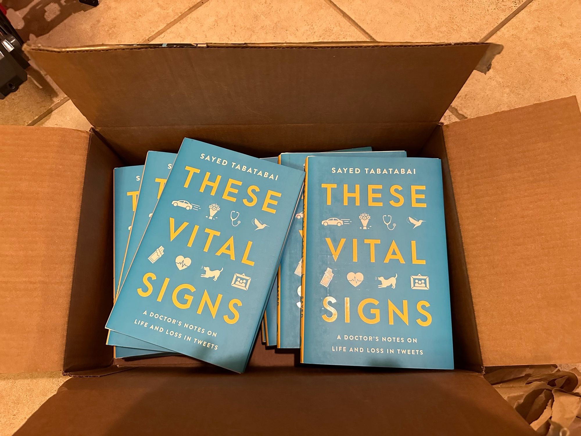 A box of books called “These Vital Signs” by Dr. Sayed Tabatabai.