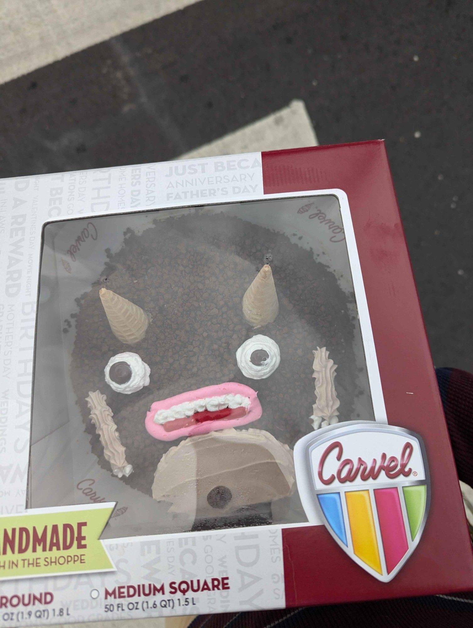 photograph of the actual cake through a carvel box, the guy looks fuuuuucked upppppp. he looks surprised and disgusted