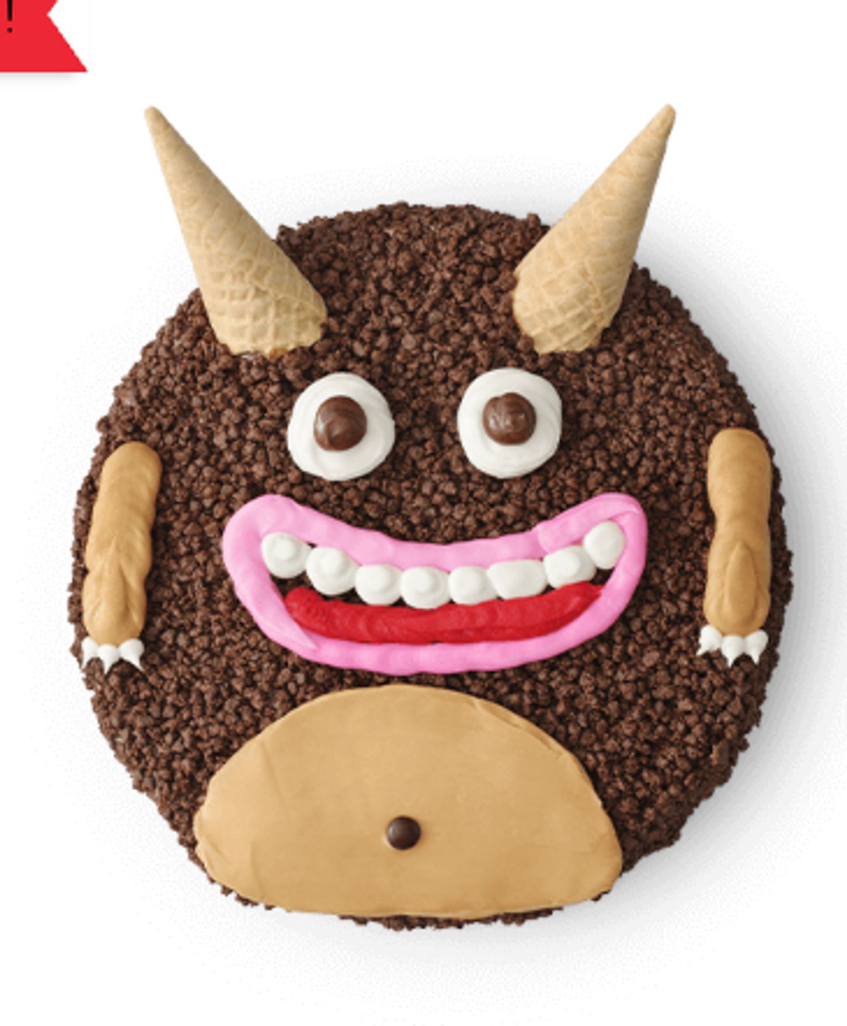 photograph of a round cake covered in chocolate crunchies with ice cream cone horns, eyes, a wide pink smile, little arms and a belly indicating a friendly little monster guy