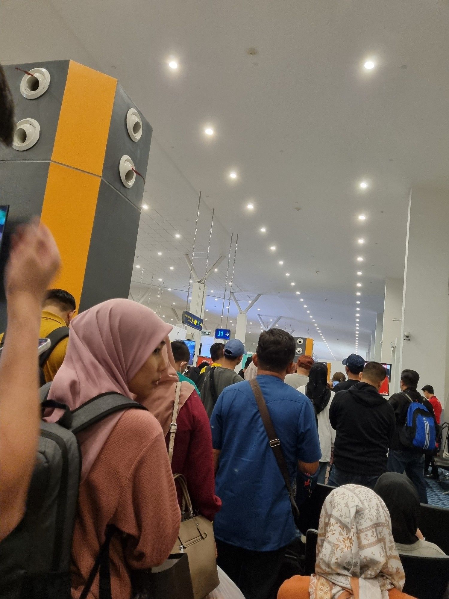 A picture of people queueing for boarding at the airport