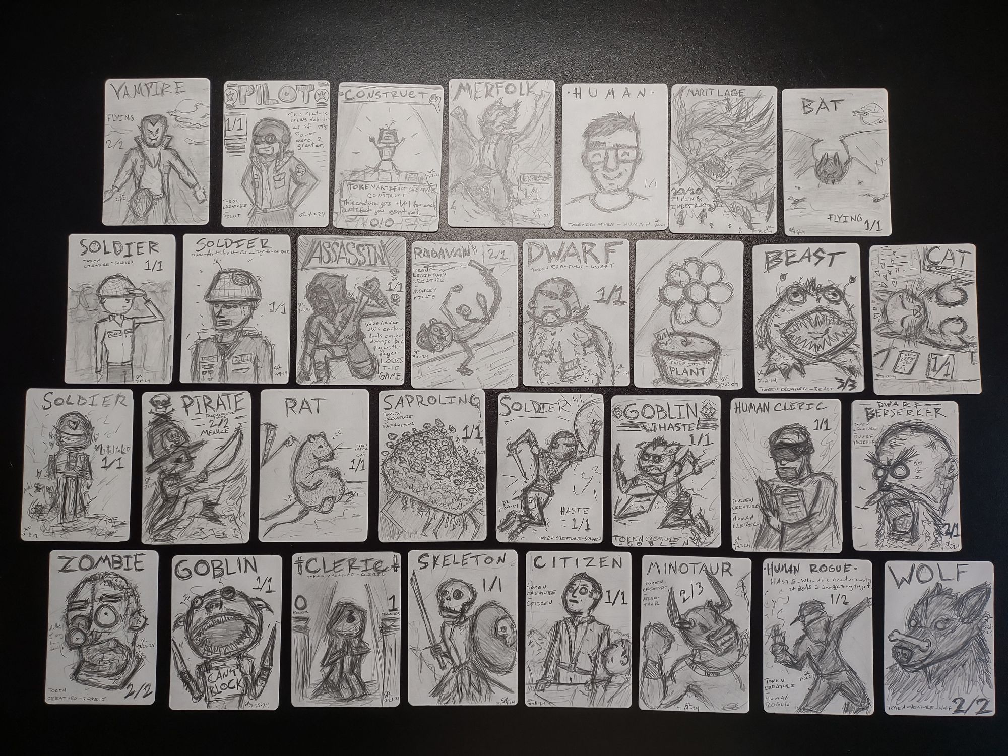 31 hand-drawn Magic the Gathering tokens on cardstock paper, one for each day of July. 
The tokens in order of date are: Vampire, Pilot, Construct, Merfolk, Human, Marit Lage, Bat, Soldier, Soldier (Artifact), Ragavan, Dwarf, Plant, Beast, Cat, Soldier (Lifelink), Pirate, Rat, Saproling, Soldier (Haste), Goblin (Haste), Cleric, Dwarf Berserker, Zombie, Goblin (that can't block), Cleric (0/1), Skeleton, Citizen, Minotaur, Human Rogue, and a Wolf.