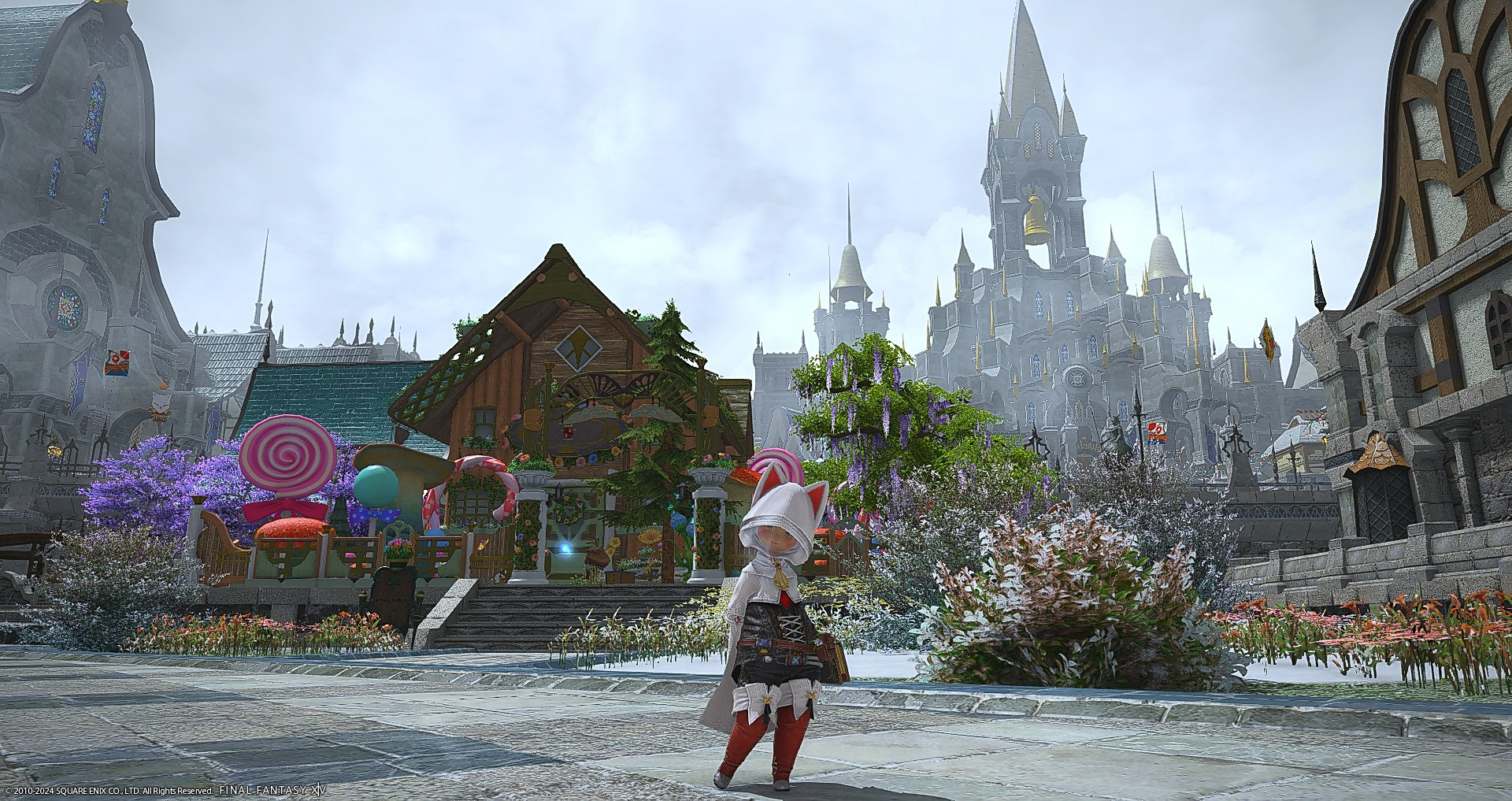 Auntie Iris, the lalafell, standing in front of her candy cottage in the Emperyum wearing a white and red furball outfit from the island sanctuary.