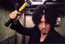 oldboy (2003). a man wields a hammer in a hallway. 