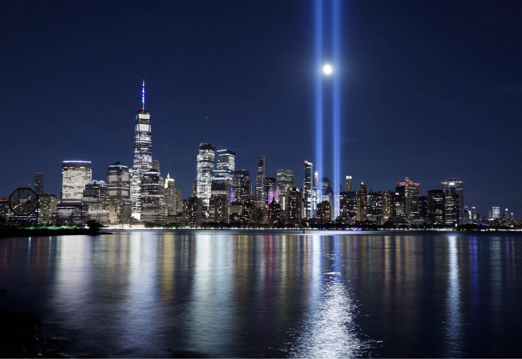 NYC skyline at night with twin light beams in memory of whee the World Trade Center towers stood.