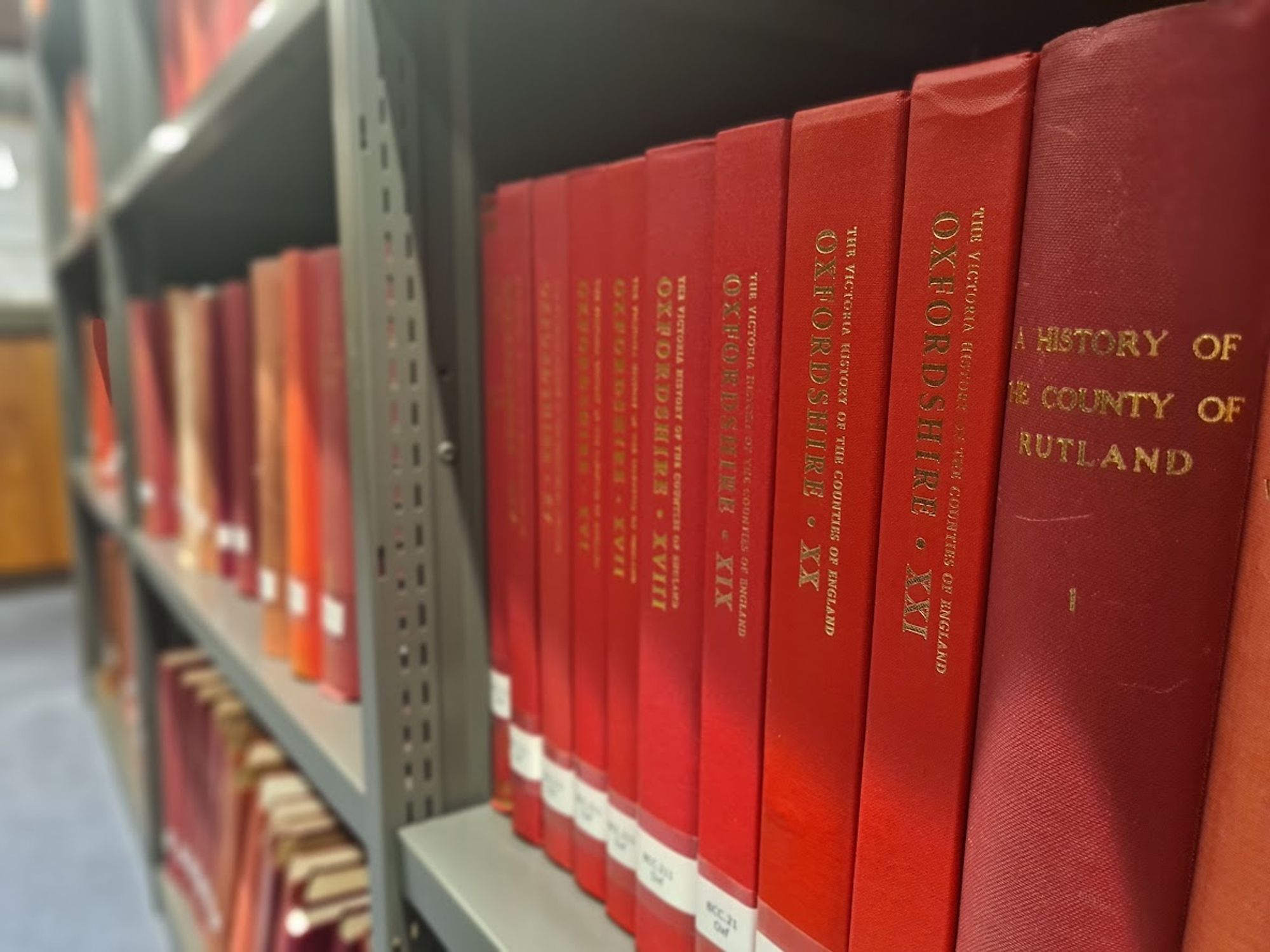 A photo of the latest Victoria County History Red Book, Oxfordshire vol. 21, on the open shelves at the IHR Library.