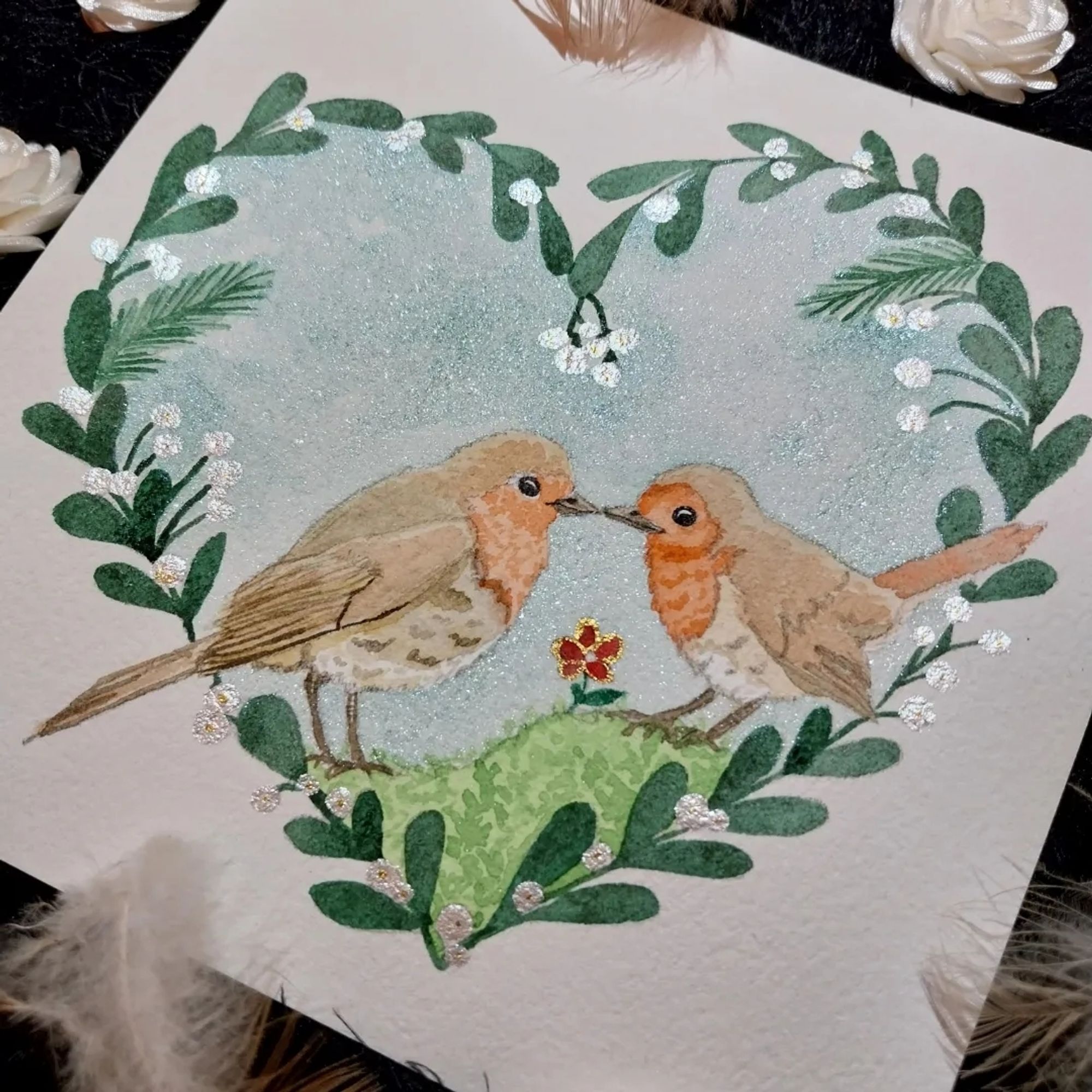 Two robin in a vegetal heart