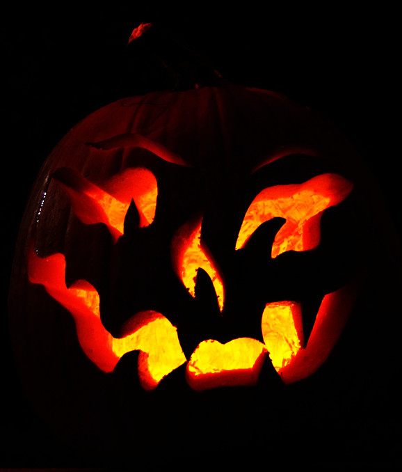 Glowing jack o lantern against a black background