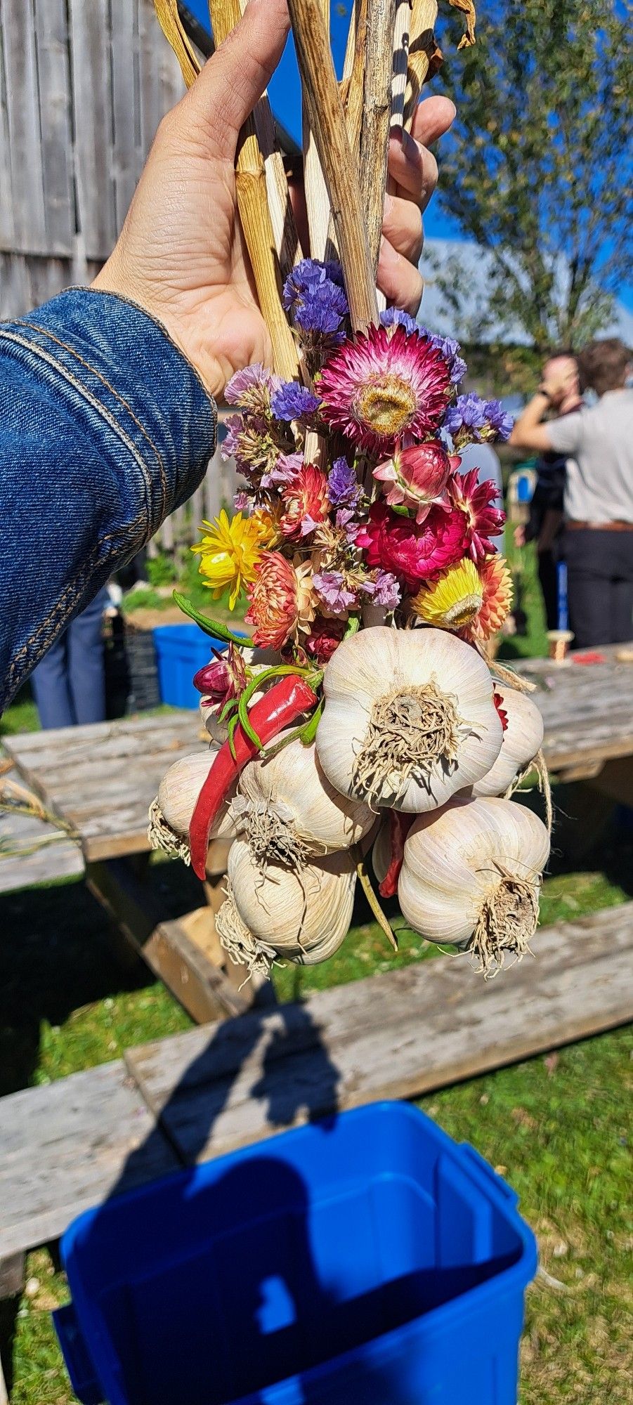 A garlic braid with dried flowers and hot peppers throughout