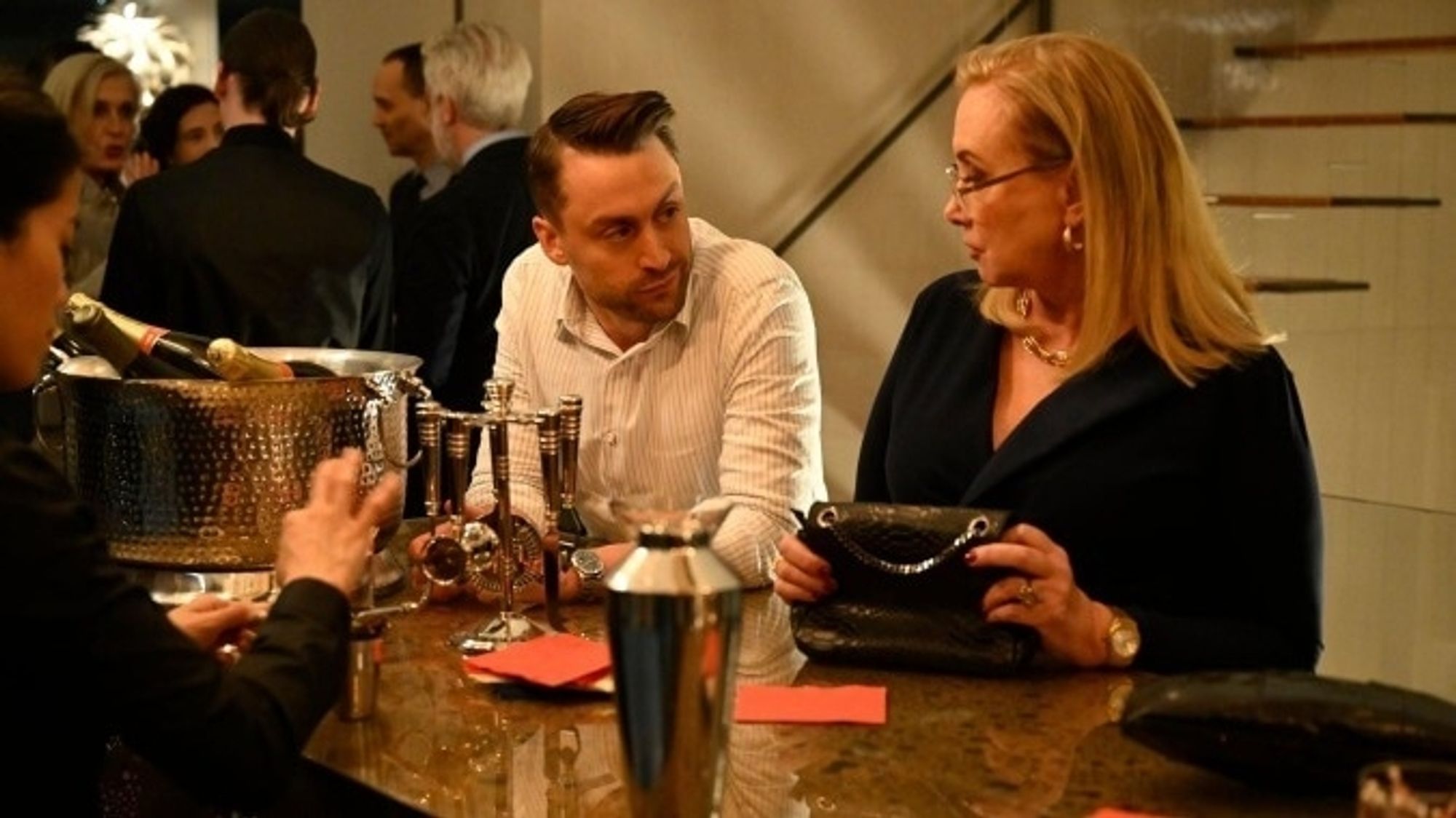 A still from Succession
Roman Roy and Gerri Kellman share an ambiguous but knowing look at a swanky bar