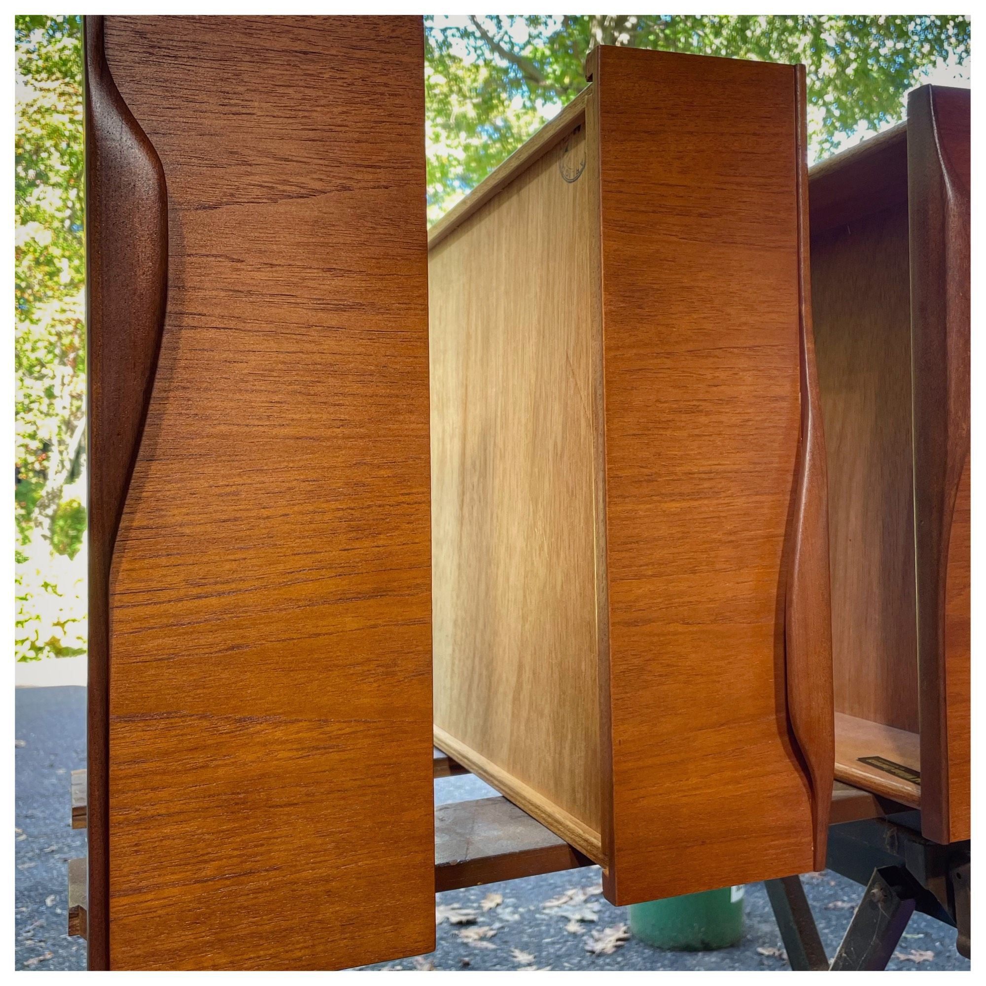 Three drawers on their sides, with a rich orange teak finish.