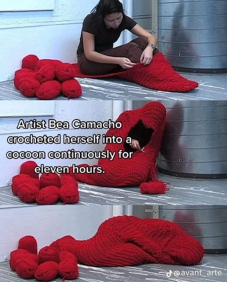 artist bea camacho crocheted herself into a cocoon continuously for eleven hours 

three photos of a woman with red yarn crocheting around herself until the last one she’s laying on the floor completely enclosed in her cocoon