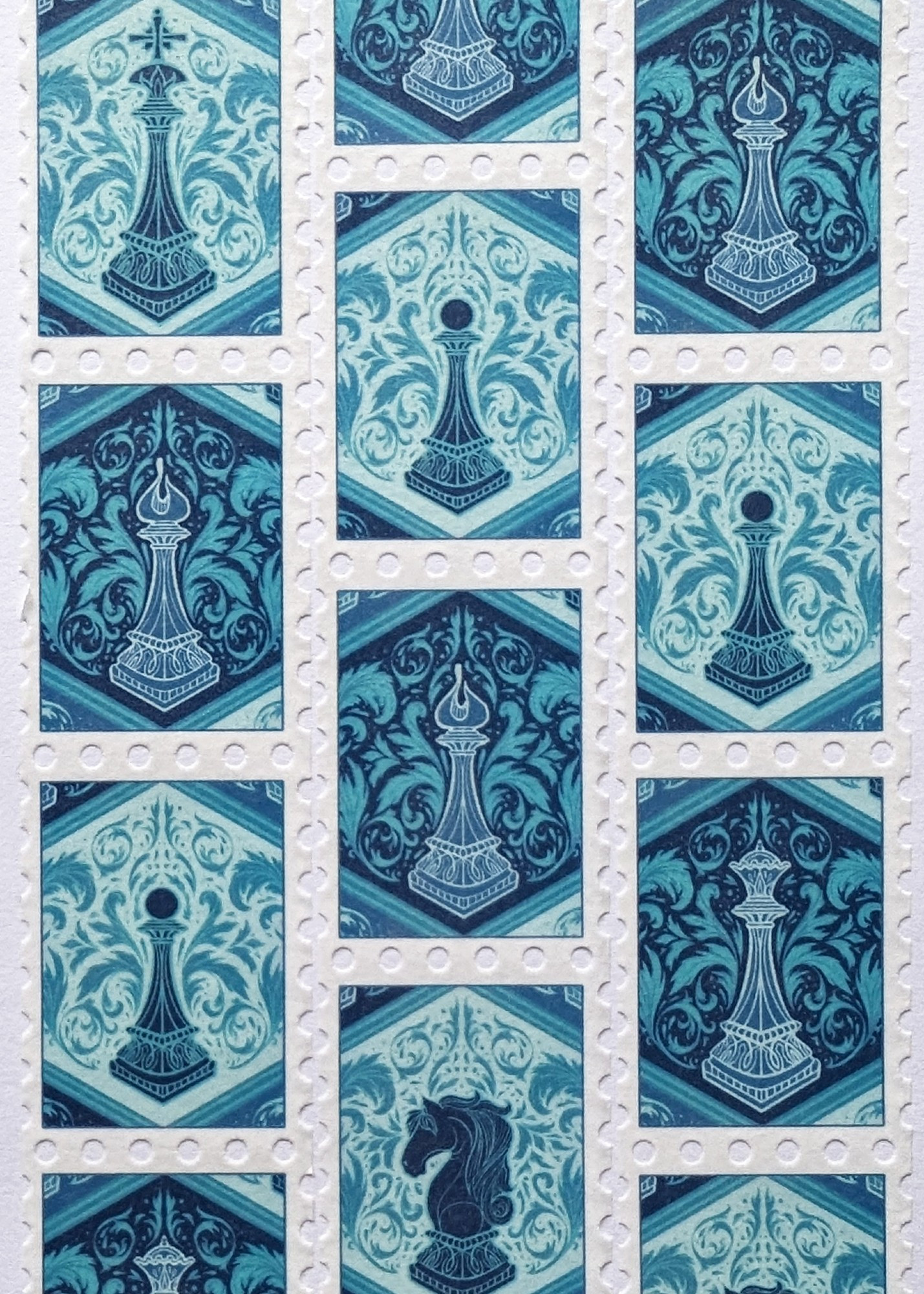 A photograph of rolls of washi tape with illustrations of blue chess pieces on it.