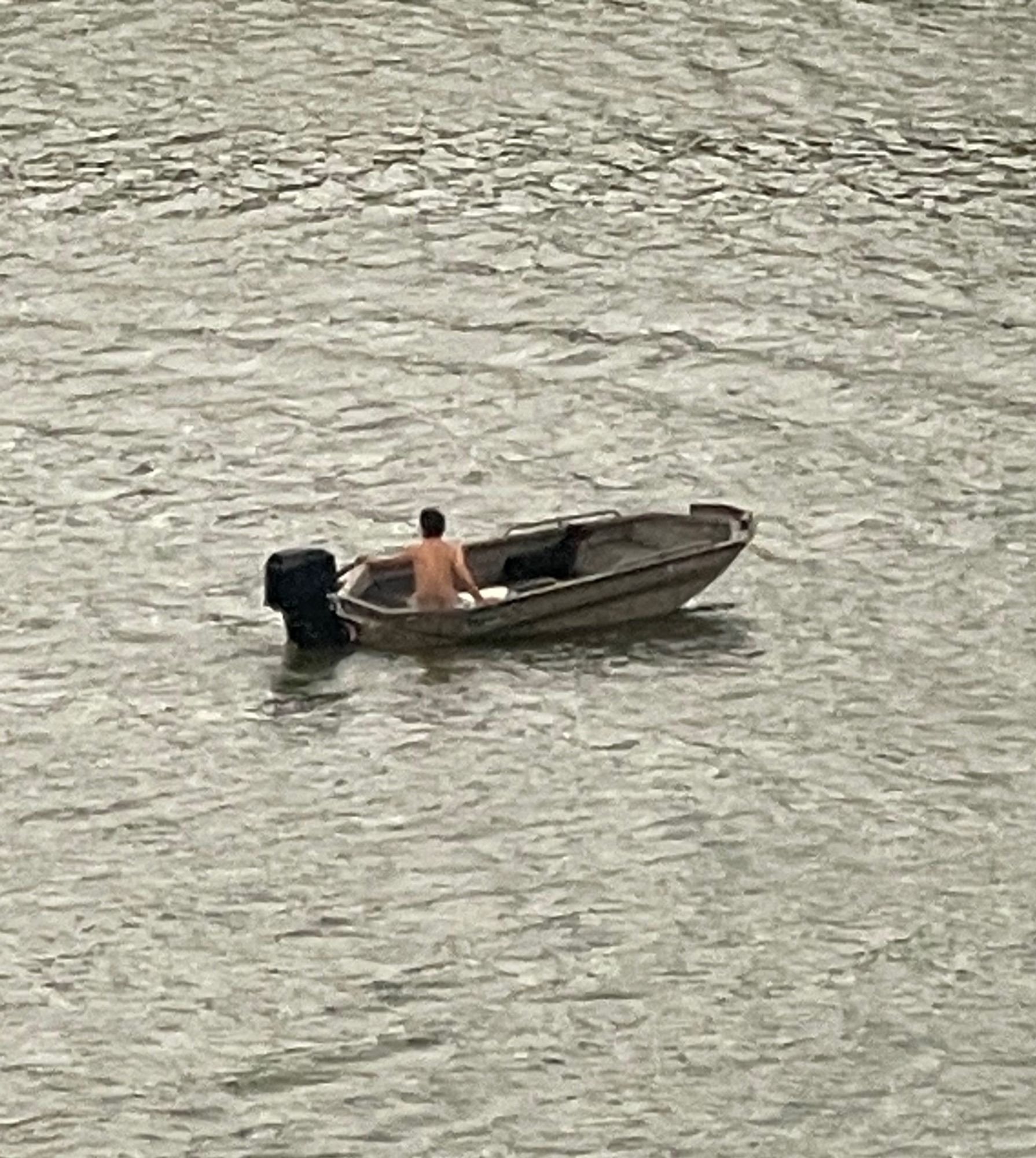 Naked dude on a small boat he probably built himself