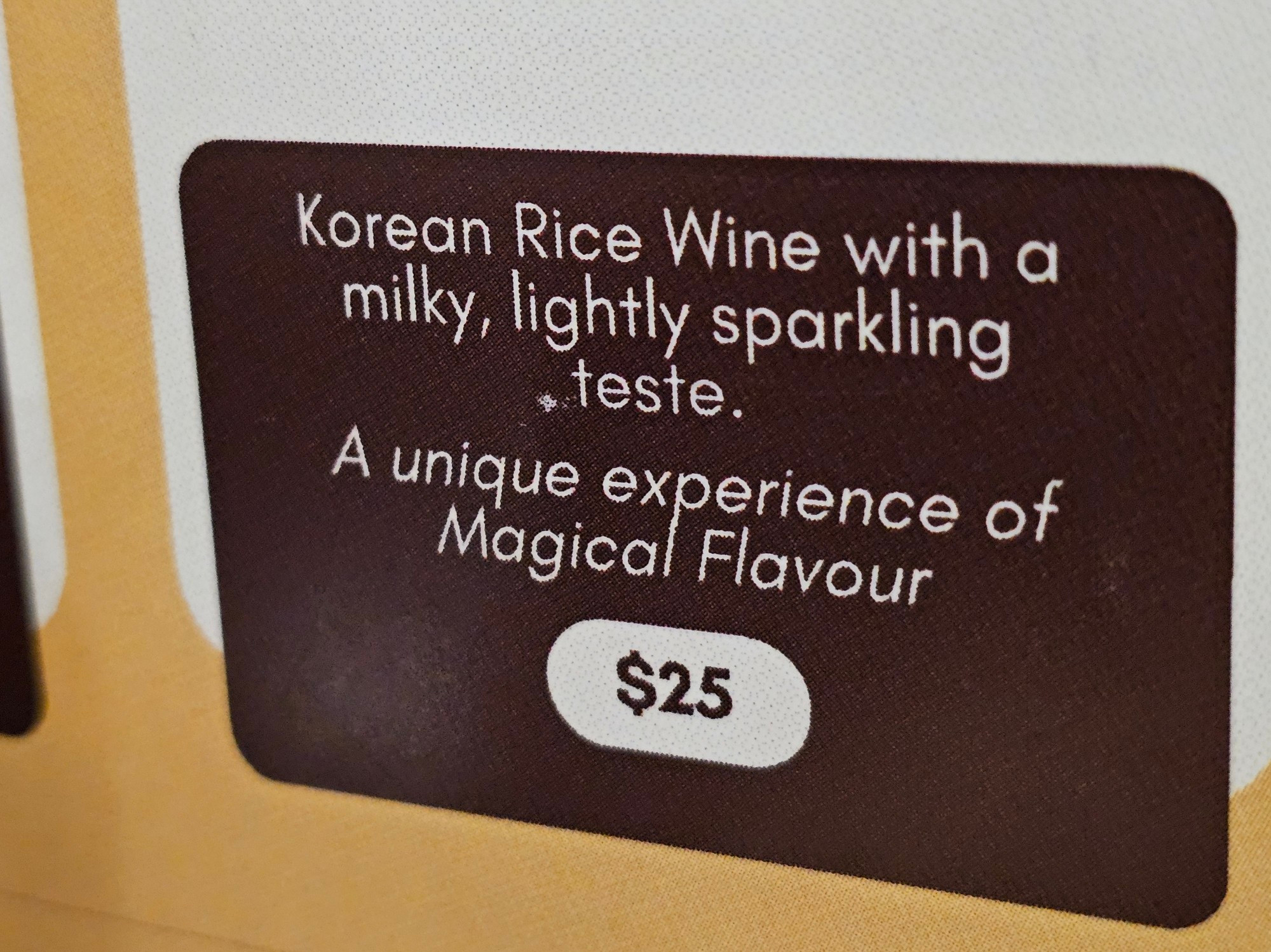 A restaurant drinks menu item that reads 'Korean Rice Wine with a milky, lightly sparkling teste. A unique experience of Magical Flavour'