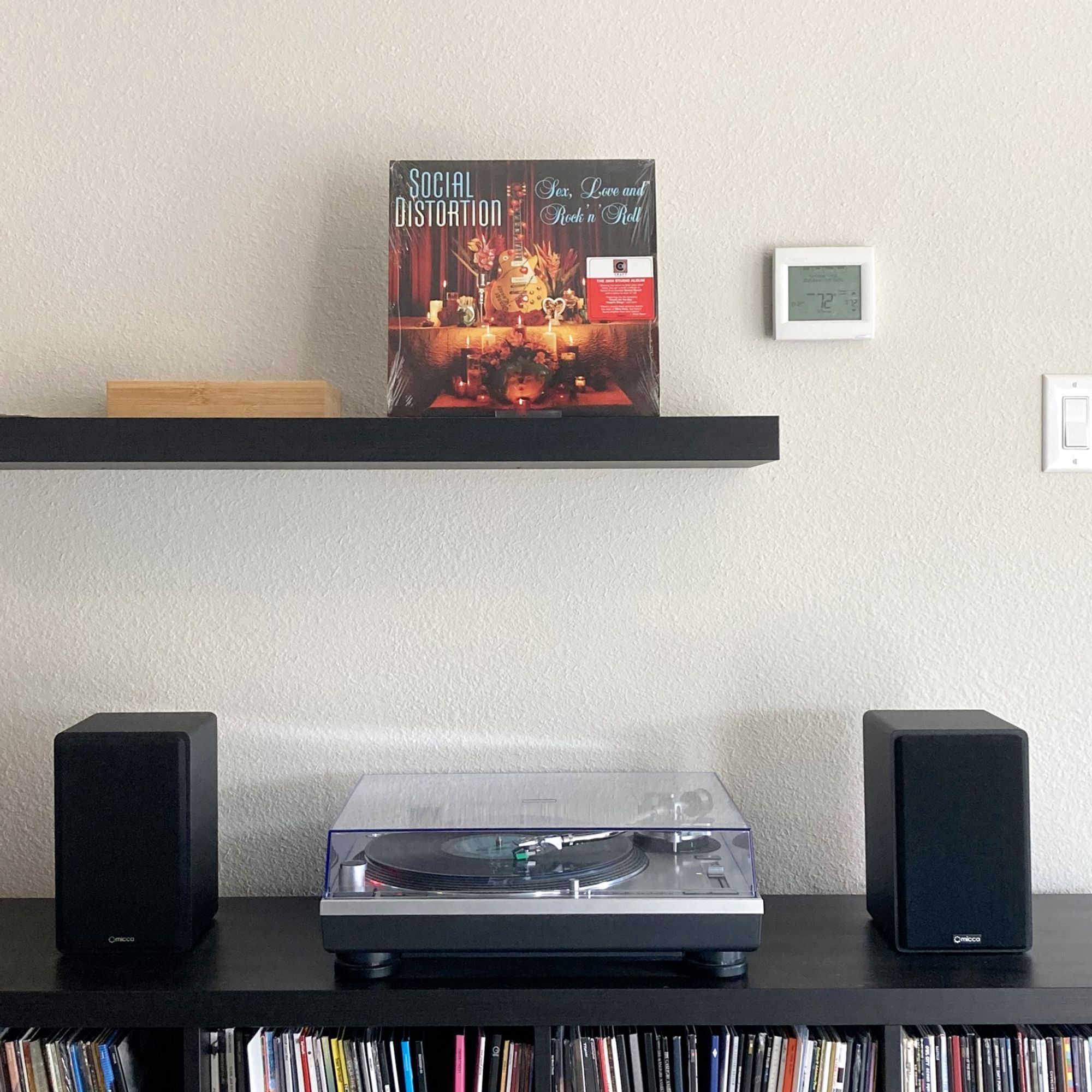 A photo of my vinyl shelves and turntable, displaying Social Distortion’s 2004 album Sex, Love and Rock ‘n’ Roll.