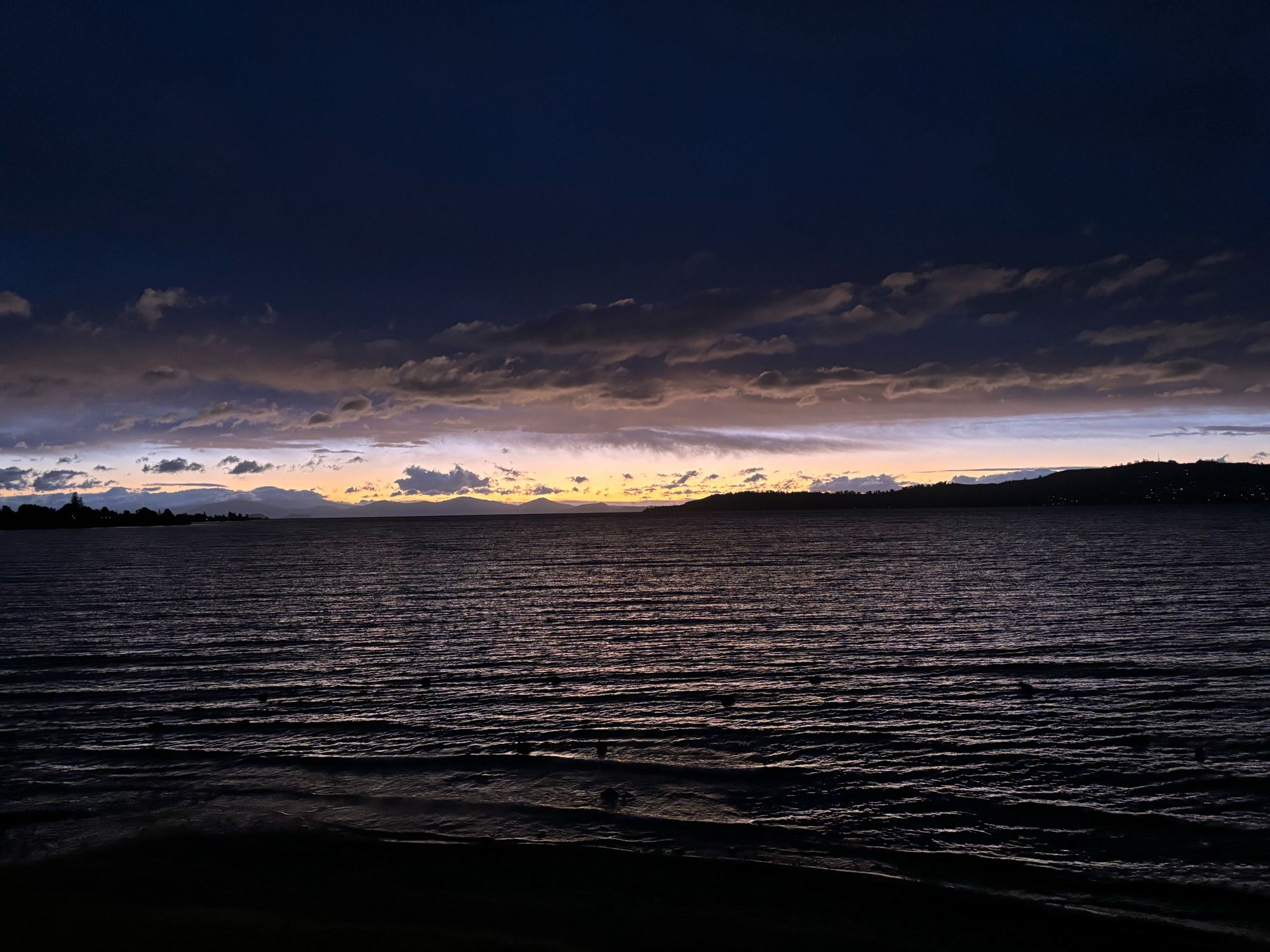 View of the sun setting over Lake Taupō.