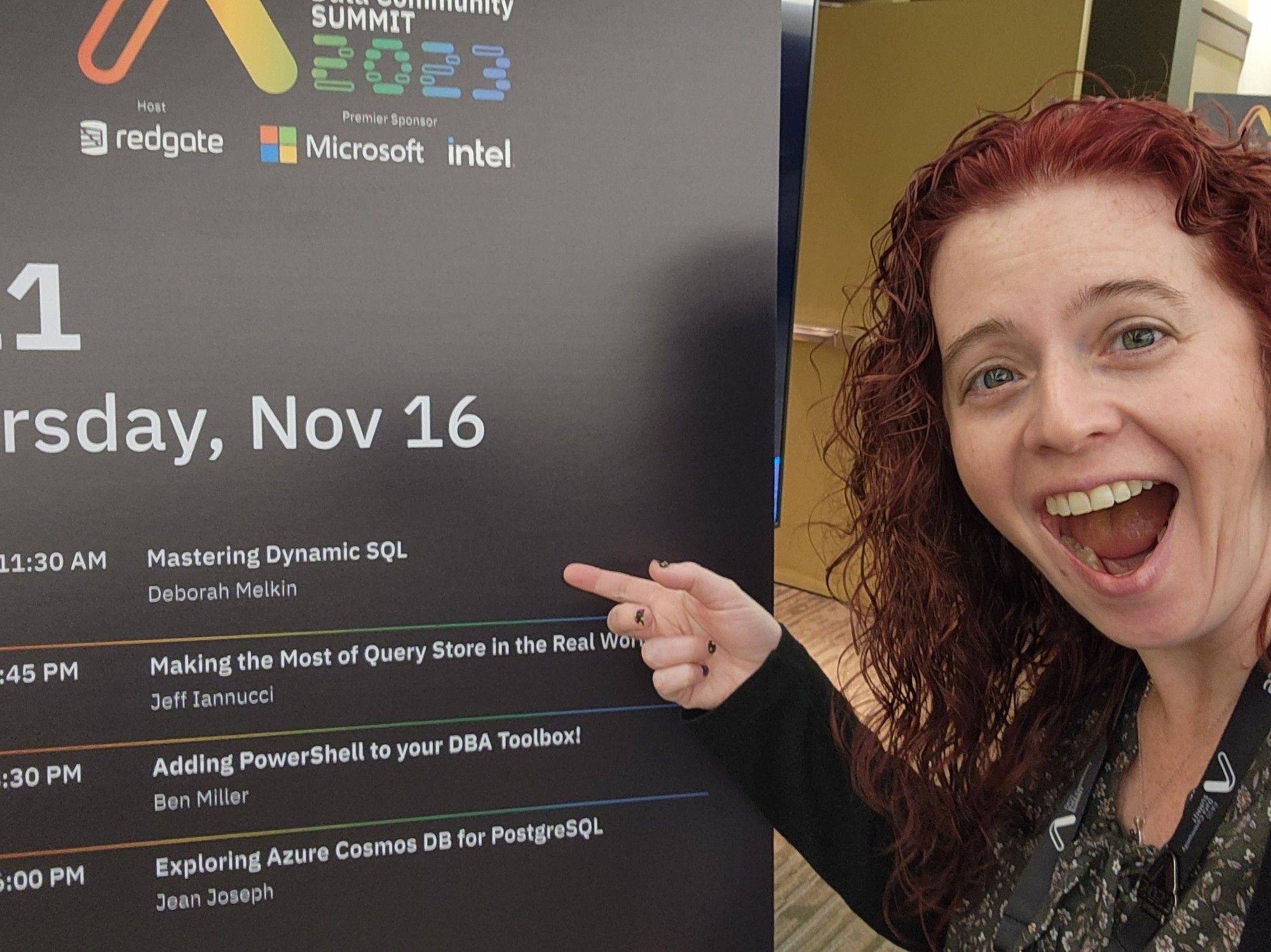 Me pointing to my session on the signage outside the room