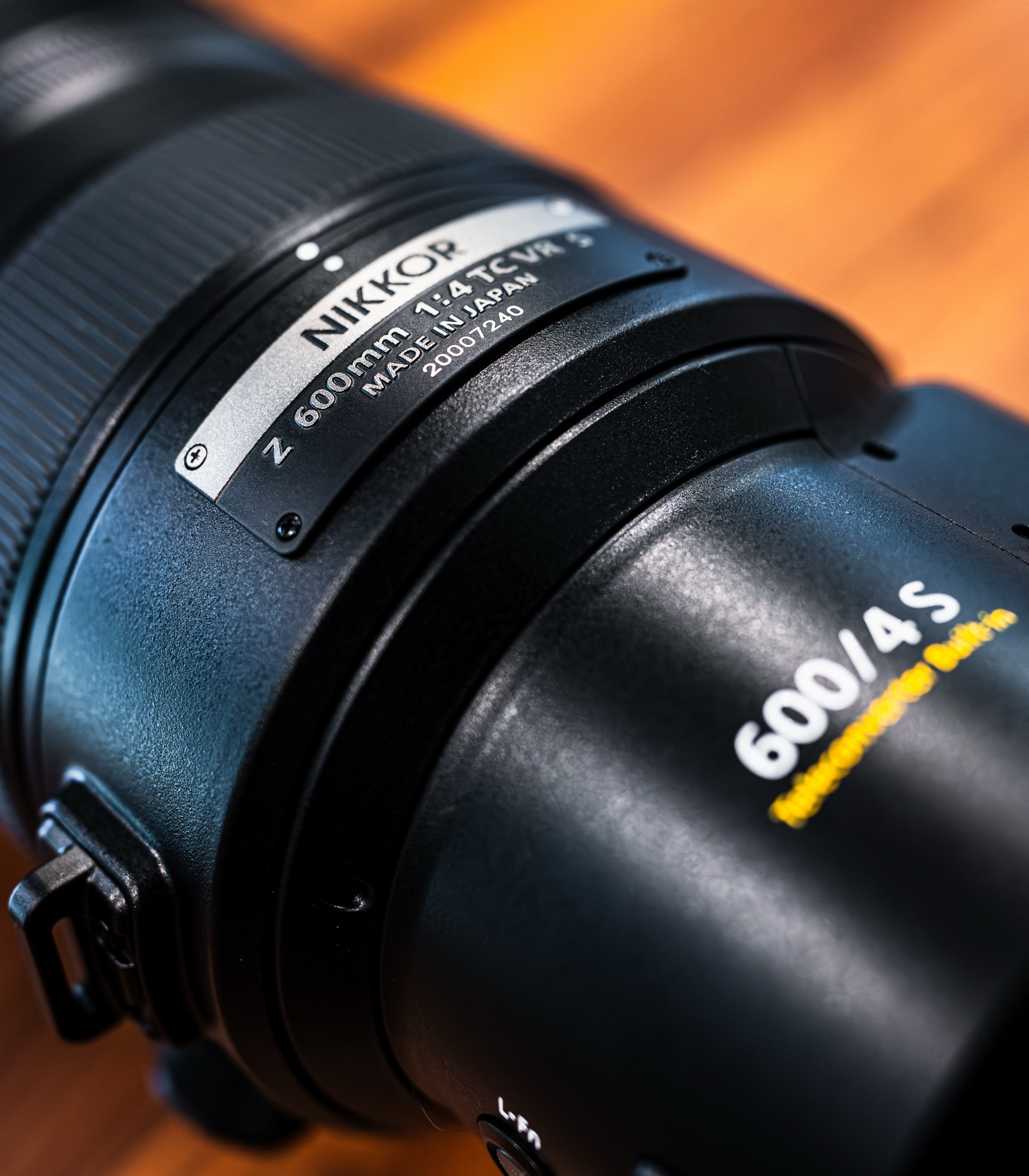 Tight closeup of branded lens badging that reads “NIKKOR Z 600mm 1:4 TC VR S”