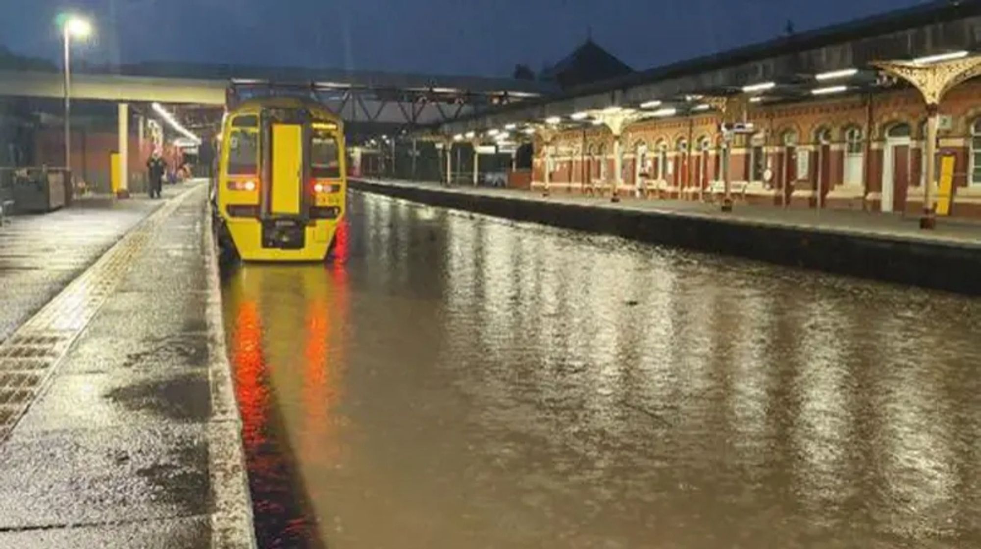 A train running on deep water through a station