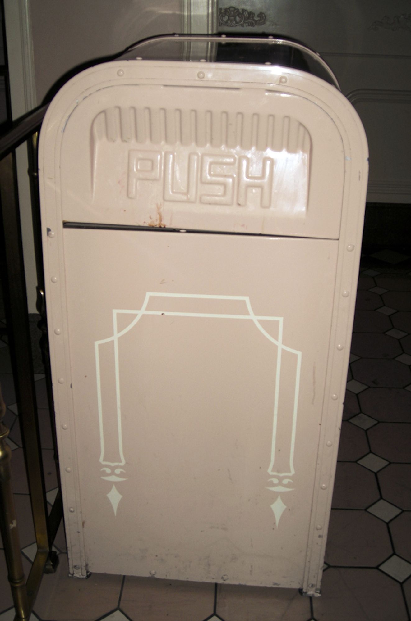 Trash can features a subtle arched design, with elements at the bottom almost hinting at facial expressions.