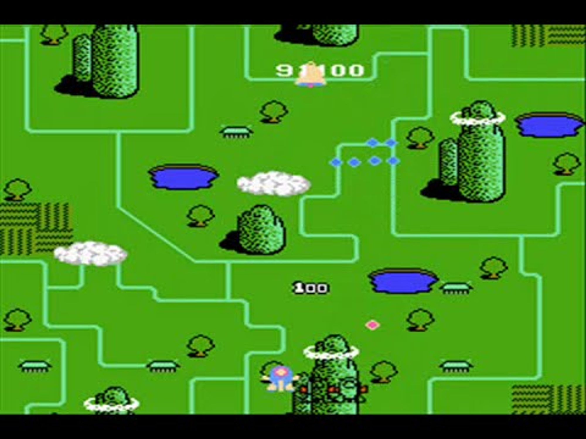 screenshot of twinbee, passing clouds over grass and a ship