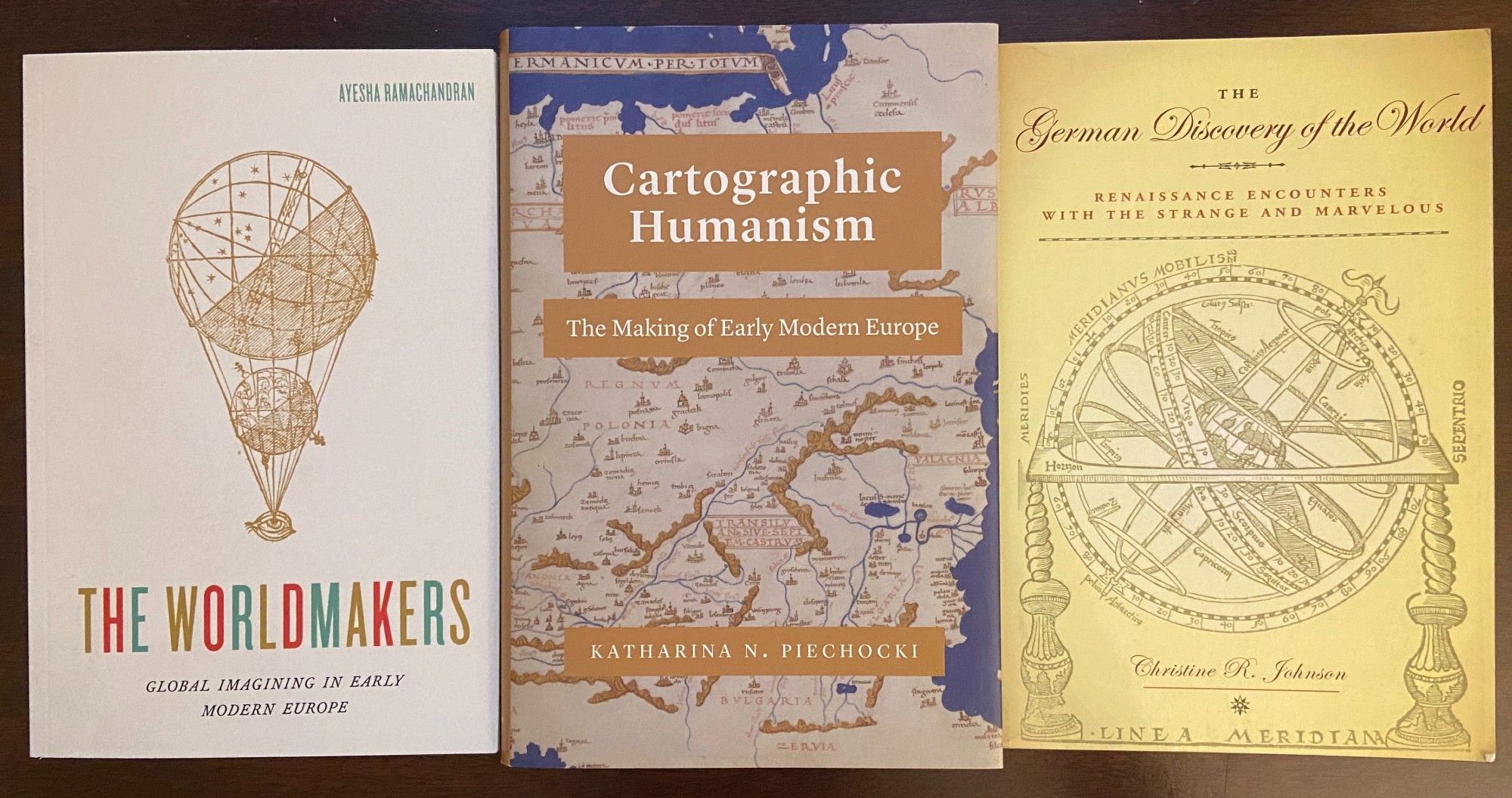 Photo of 3 books: The Worldmakers, by Ayesha Ramachandran; Cartographic Humanism, by Katharina Piechocki; and The German Discovery of the World, by Christine Johnson.