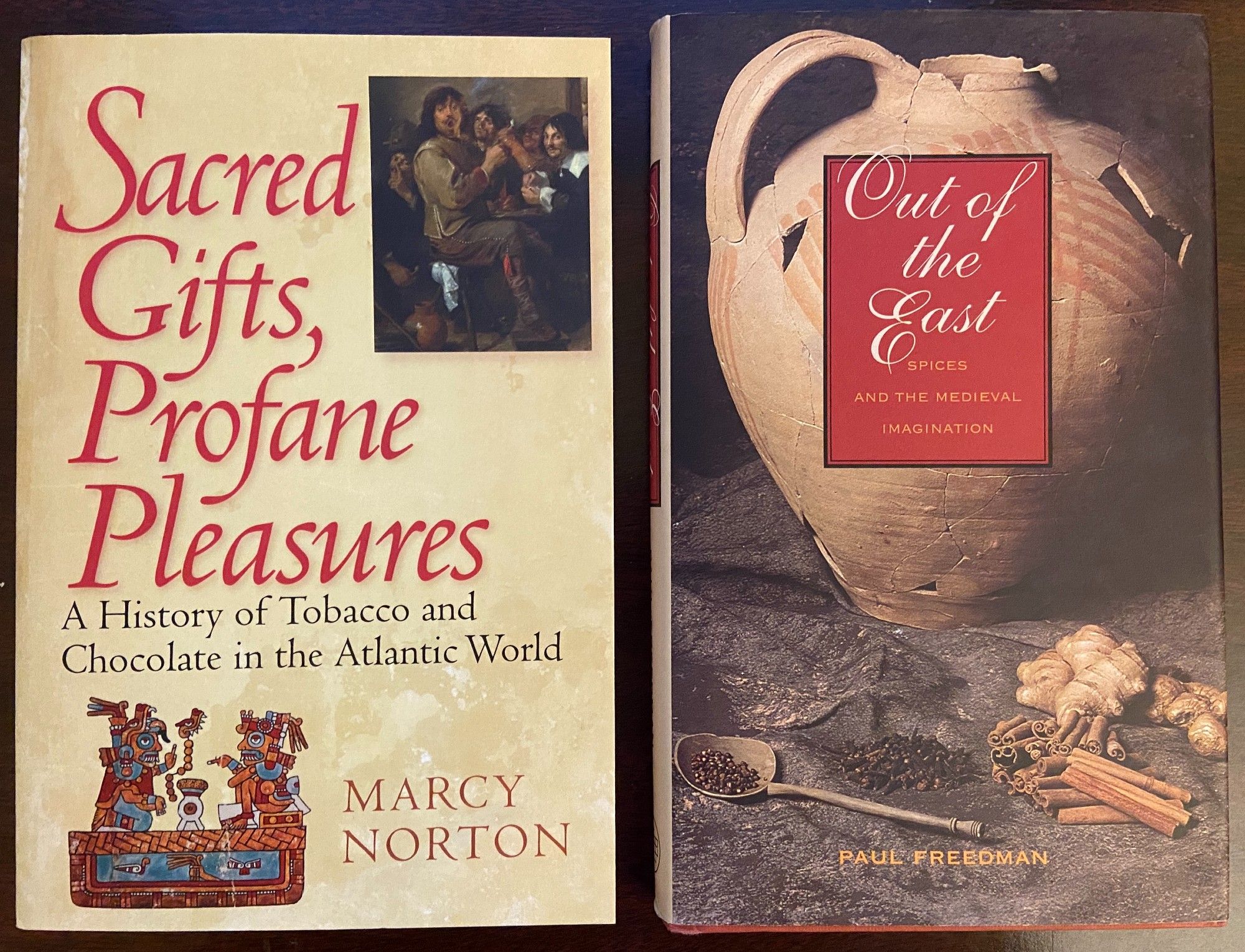 Photo of 2 books: Sacred Gifts, Profane Pleasures, by Marcy Norton; and Out of the East, by Paul Freedman.