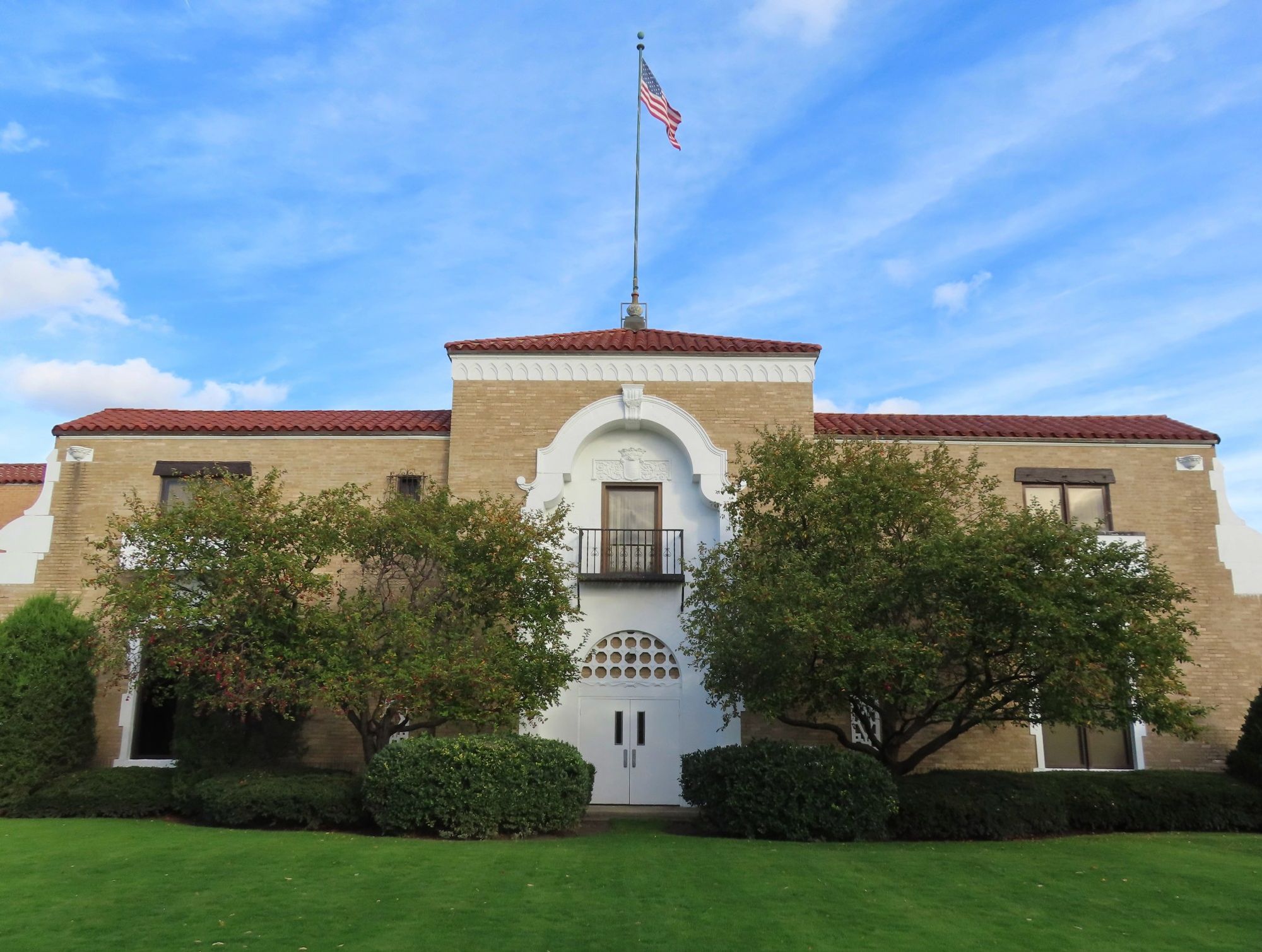 The former entrance to the building, with an elaborate two-story arch  over a balcony and the doors.