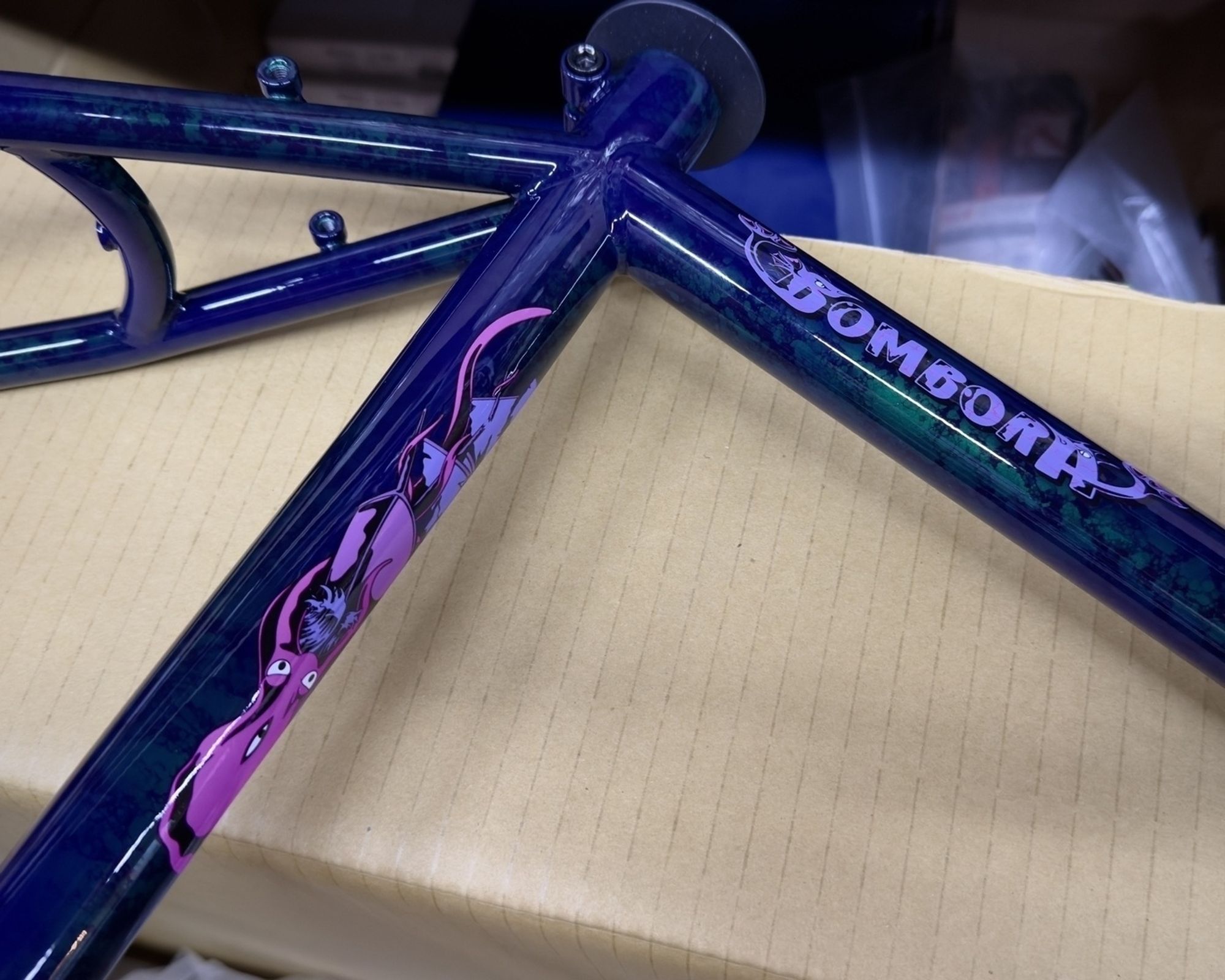 Part of a Crust Bombora bike frame with the word “Bombora” on the top tube