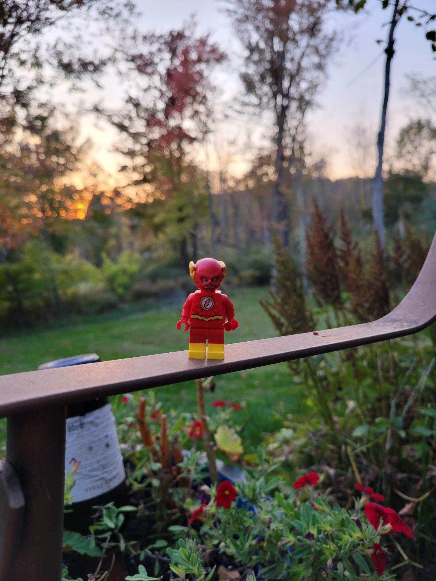 Lego Flash, a Lego mini figure of the superhero The Flash, standing top of a bench