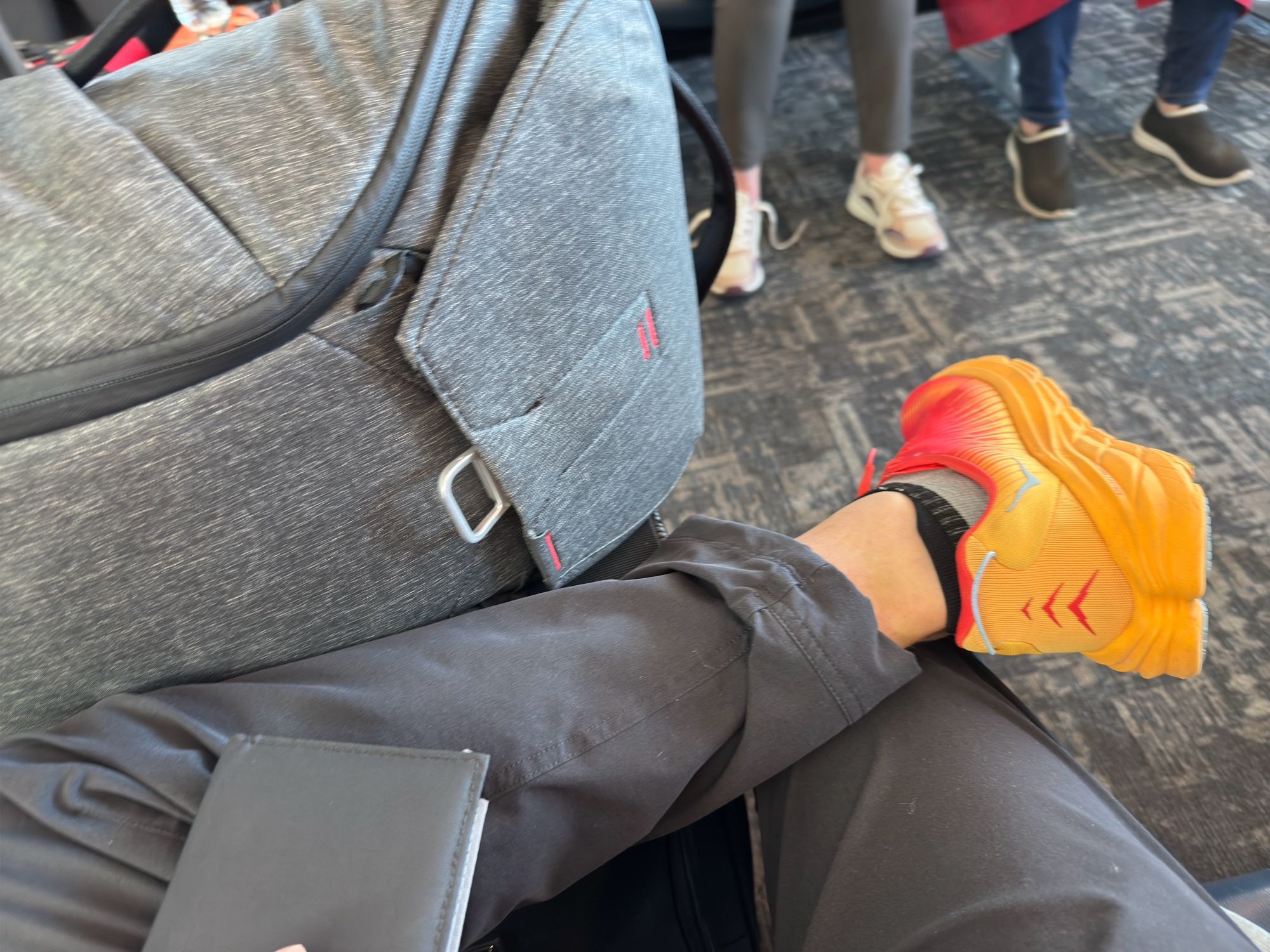 Shoes and luggage at airport gate.