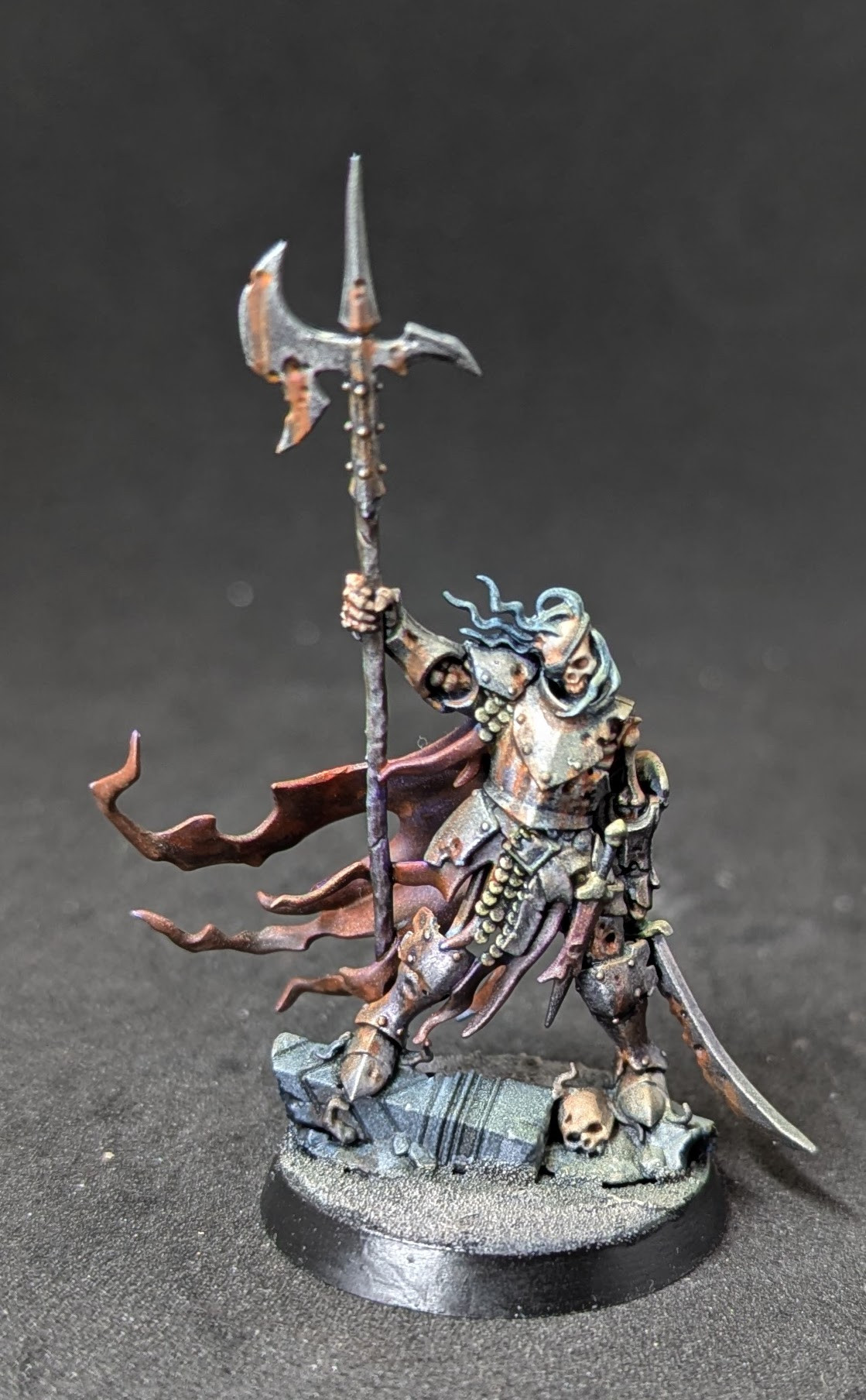 A Photo of a Watch Captain Halgrim miniature figure from Games Workshop's Age of Sigmar range. He's a skeleton wearing armour and holding a sword and halberd.