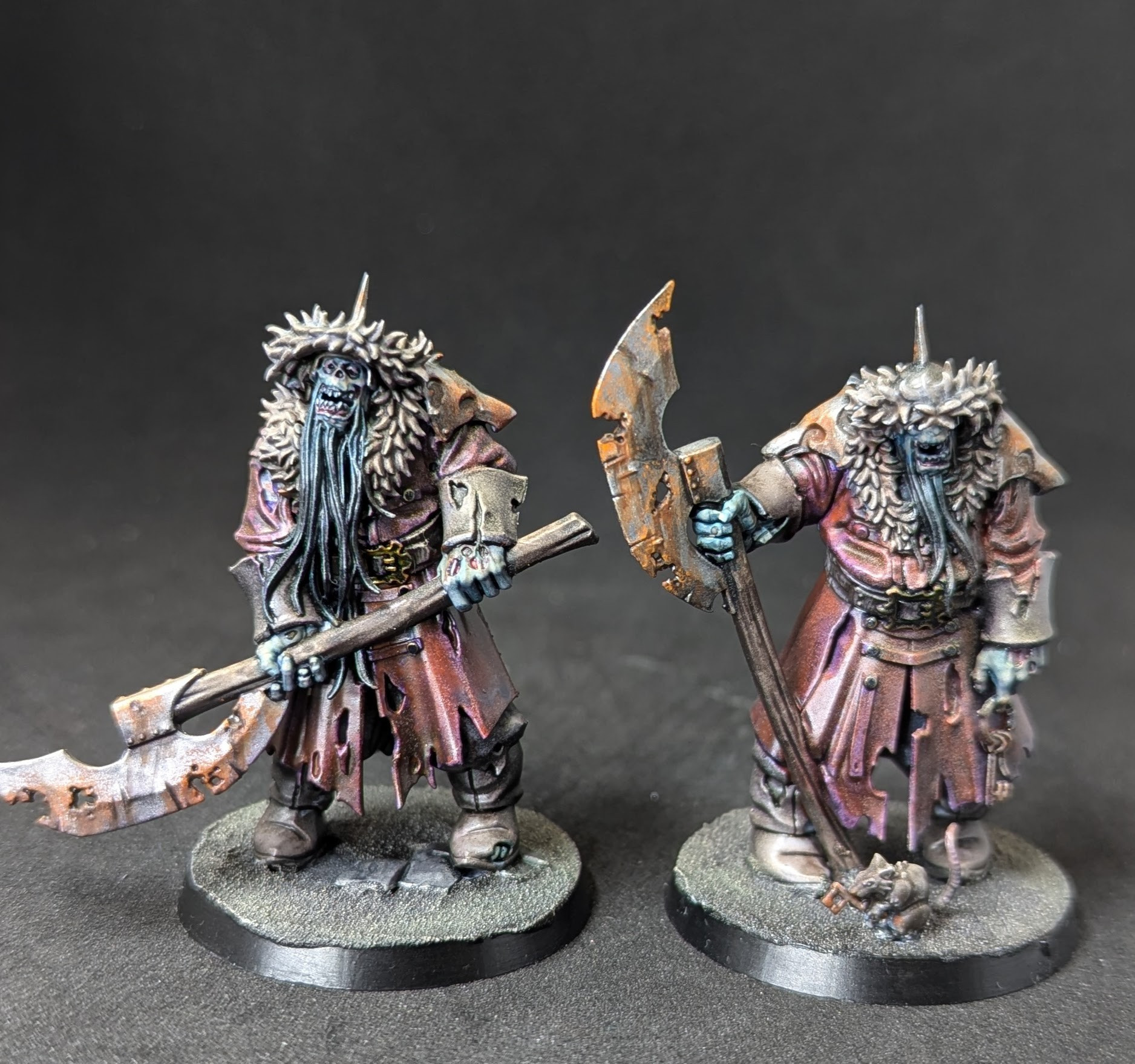 Two Korsagi Night guard miniature figures from Games Workshop's Age of Sigmar range. They are zombie ogres wearing clothes that look Mongolian or Siberian