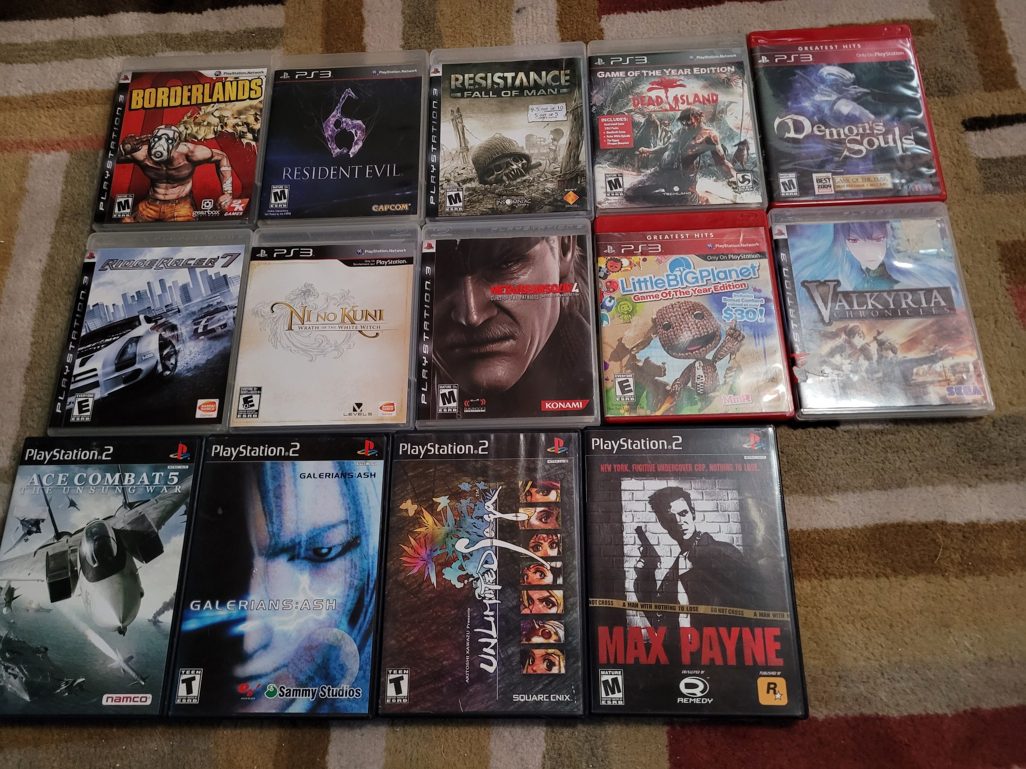 A bunch of games laid out including the Ps3 games: Borderlands 1, Resident Evil 6, Resistance Fall Of Man, Dead Island GOTY Edition, Demon's Souls Greatest Hits, Ridge Racer 7, Ni No Kuni 1, Metal Gear Solid 4, LittleBIGPlanet GOTY Edition, Valkyria Chronicles 1.

Also the Ps2 games: Ace Combat 5, Galerians:Ash, Unlimited SaGa, and Max Payne 1.