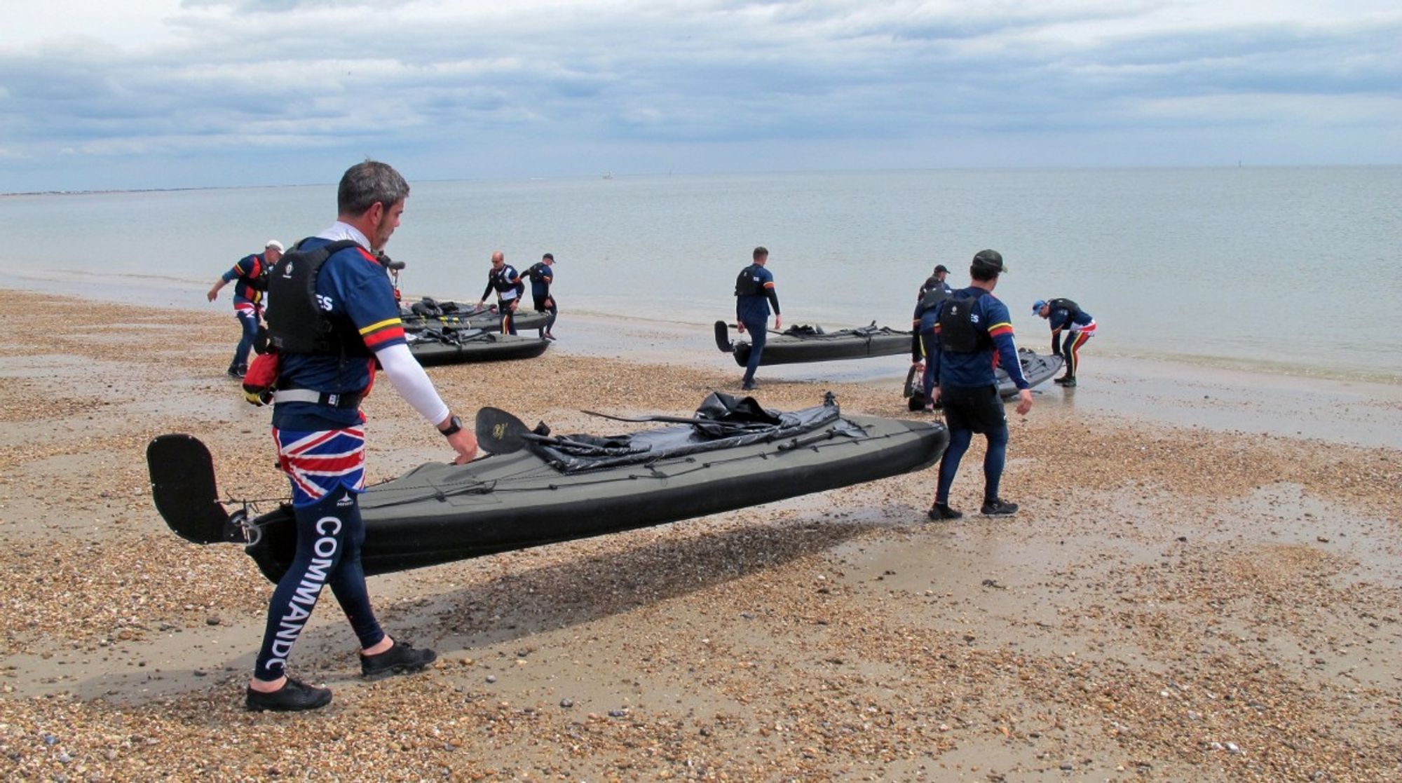 Carrying their kayaks from the former Royal Marines barracks at Eastney, in Portsmouth, to the water.