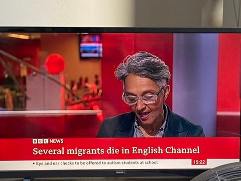 A TV showing the BBC News channel. On screen, a grey-haired woman (I don't know who it is) looking down at her notes.

Across the bottom of the screen, a chyron: the BBC News logo, then the headline "Several migrants die in English Channel".