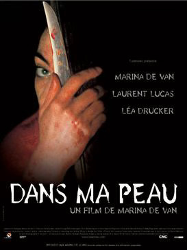 A woman holds a bloody knife in front of her obscured face in a bloody hand. Reads “Dans ma Peau”