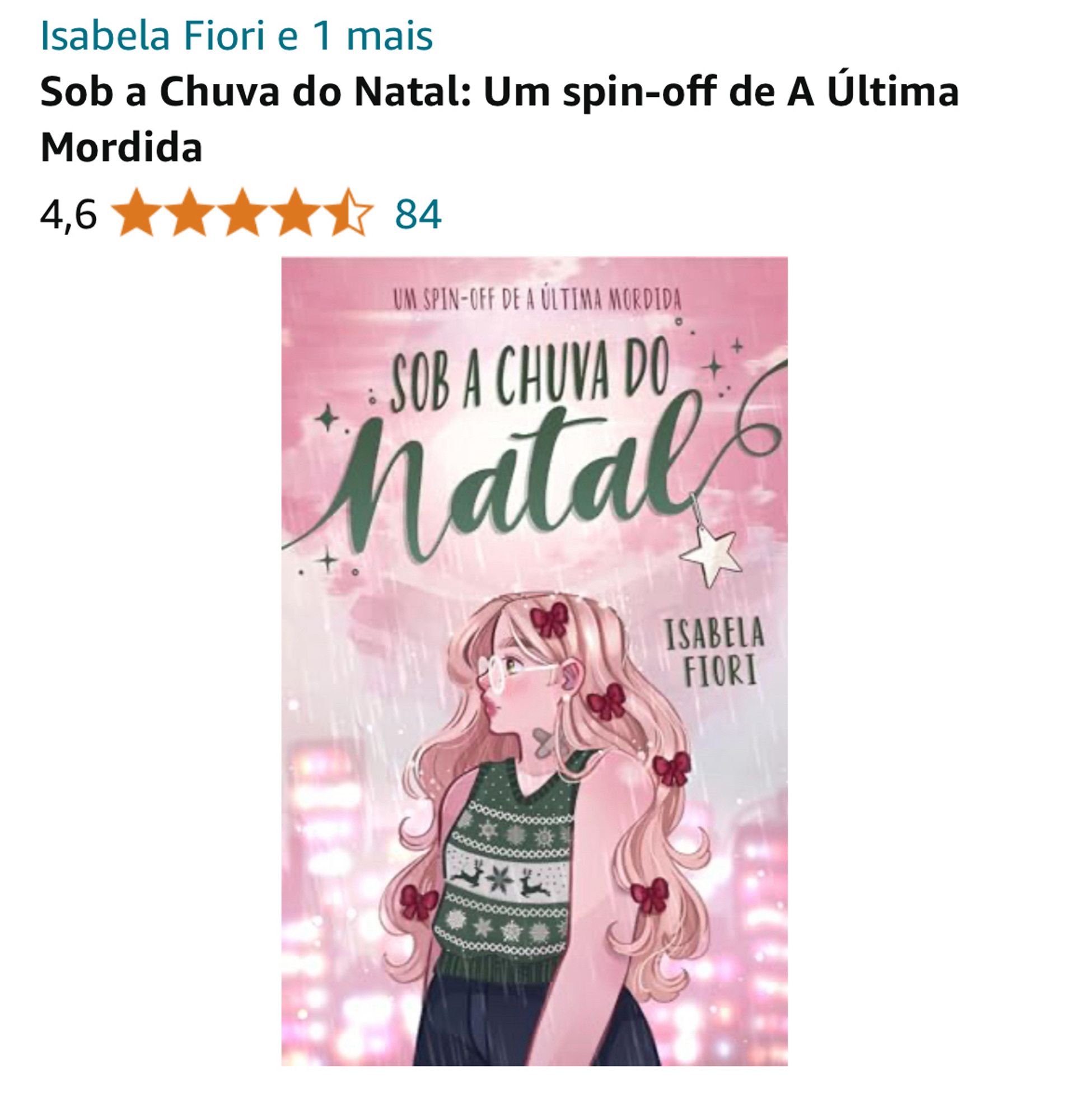 Print de uma página de venda de livro, mostrando a capa do livro 'Sob a Chuva do Natal: Um spin-off de A Última Mordida' por Isabela Fiori. A avaliação do livro é de 4,6 estrelas com base em 84 resenhas. A capa do livro apresenta uma ilustração de uma jovem mulher de cabelos longos e loiros, usando óculos e um suéter de Natal verde e dois band-aids cruzados no pescoço. Ela está olhando para o lado, com um fundo rosa que sugere uma cena de chuva à noite, com luzes de uma cidade ao fundo.