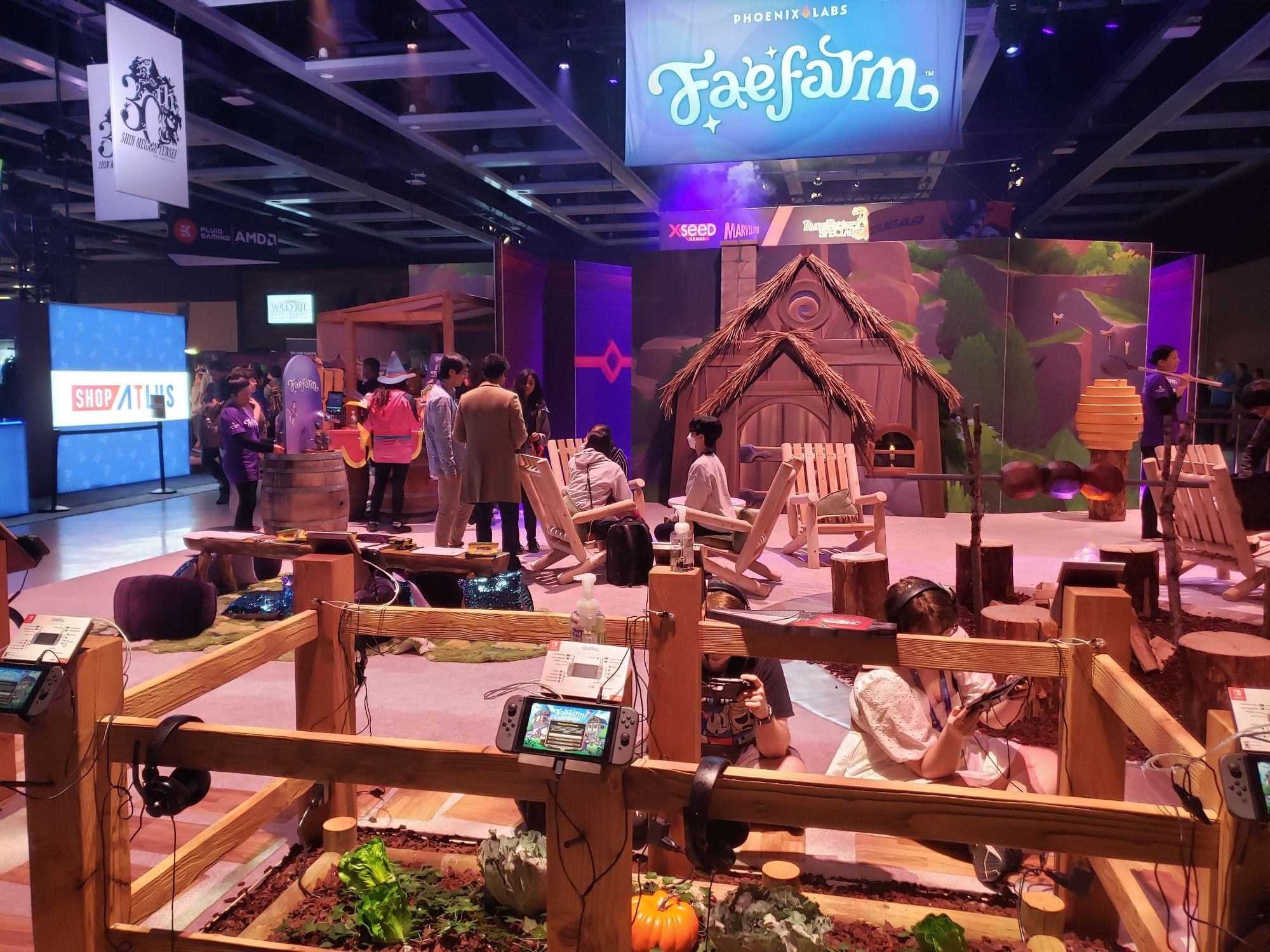 A photograph of the Fanfare booth, with a cozy dake fireplace, wooden chairs, and fairytale lighting