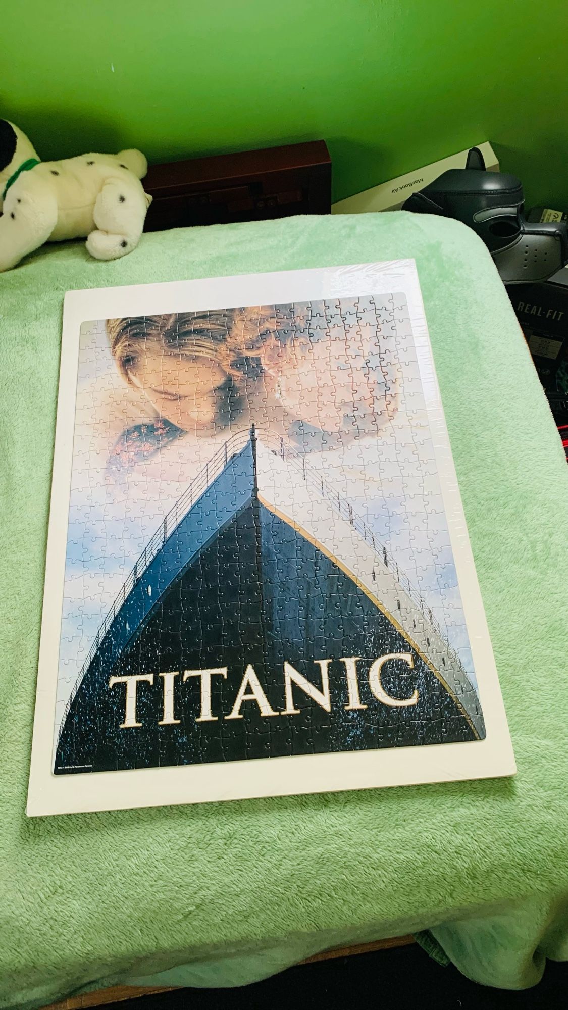 Titanic title on bottom of the ship, RMS Titanic ship, light color background, and two characters on top. 1997, Paramount movie theater poster.