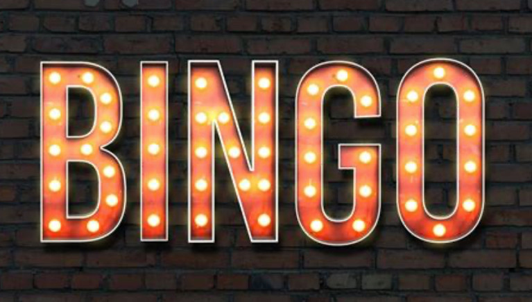 Graphic depicting the letters “BINGO” on a dark brown brick wall.  The letters are styled as if they are part of a old incandescent bulb sign.