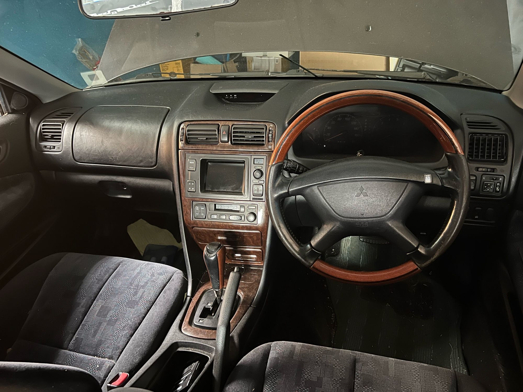 Car interior with wood grain wheel and instrument cluster