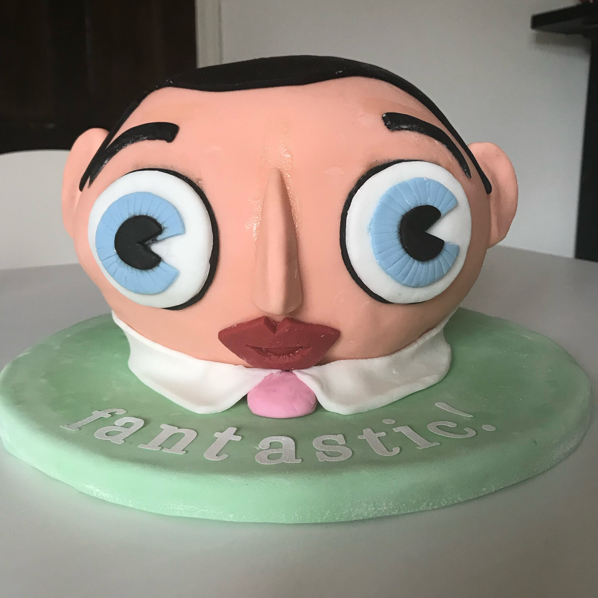 A cake in the approximate shape of Frank Sidebottom’s papier mache head.