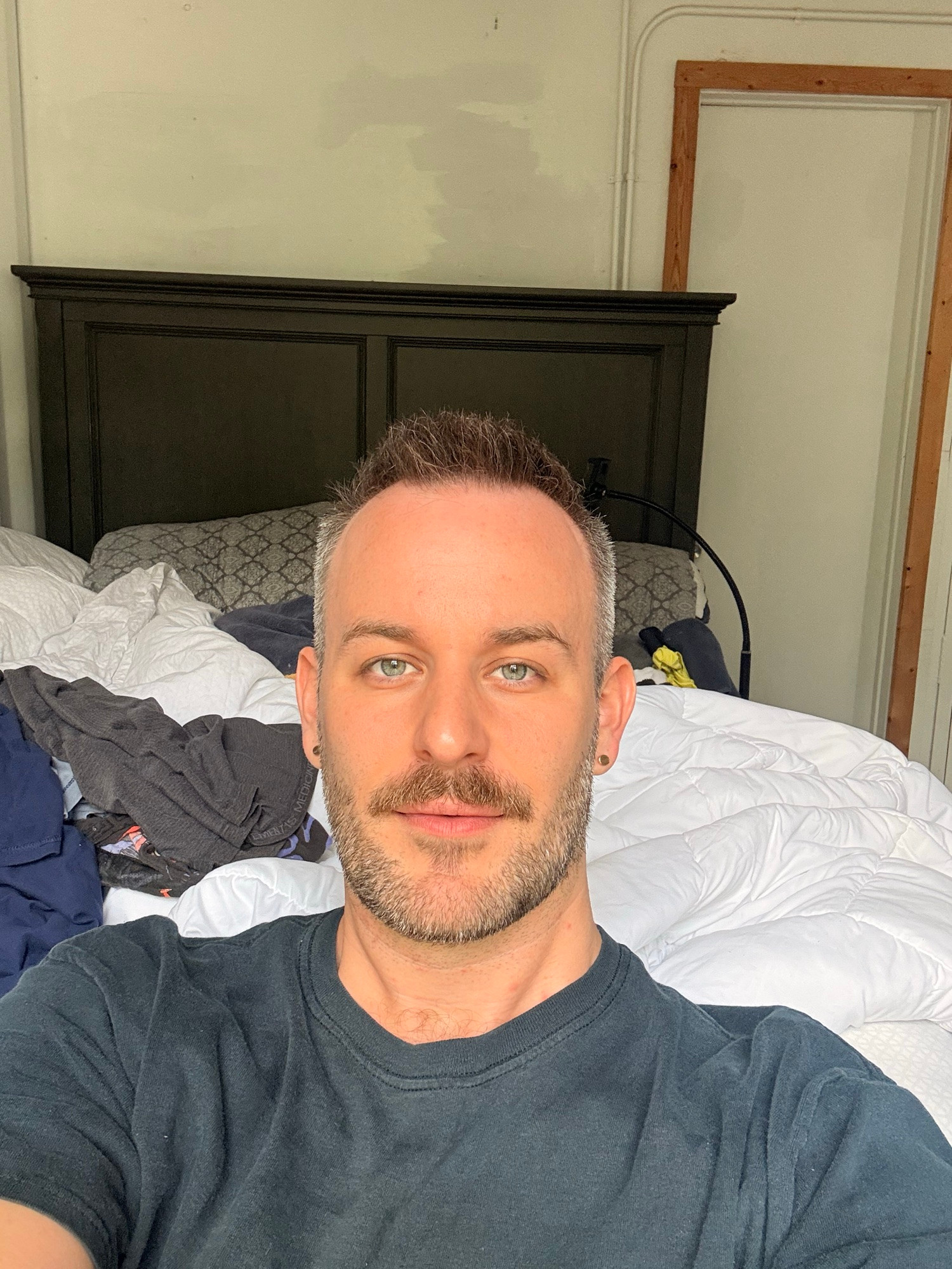Selfie with a black shirt and trimmed beard with a mustache