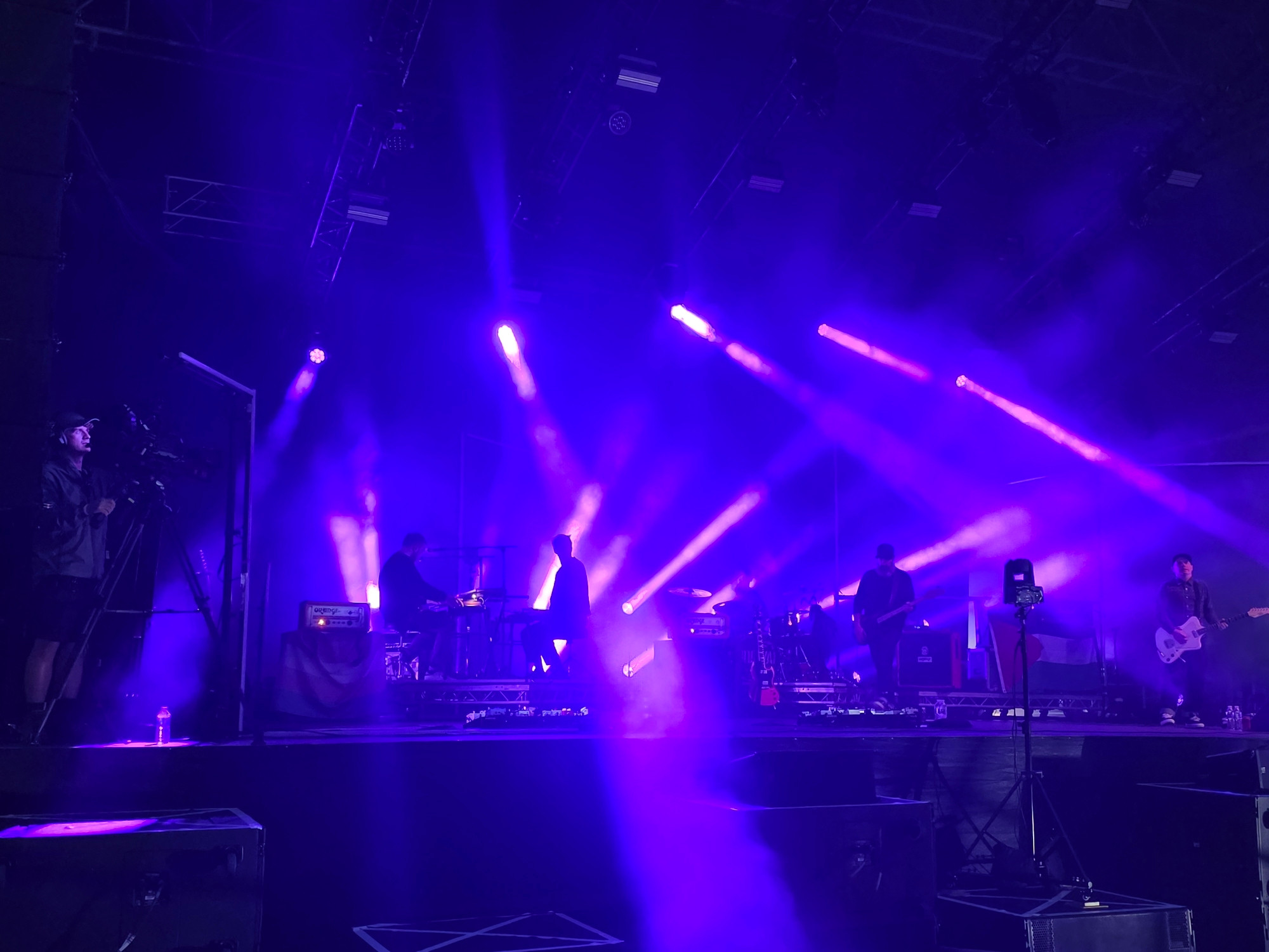 Lots of purple spotlights illuminating a stage. 