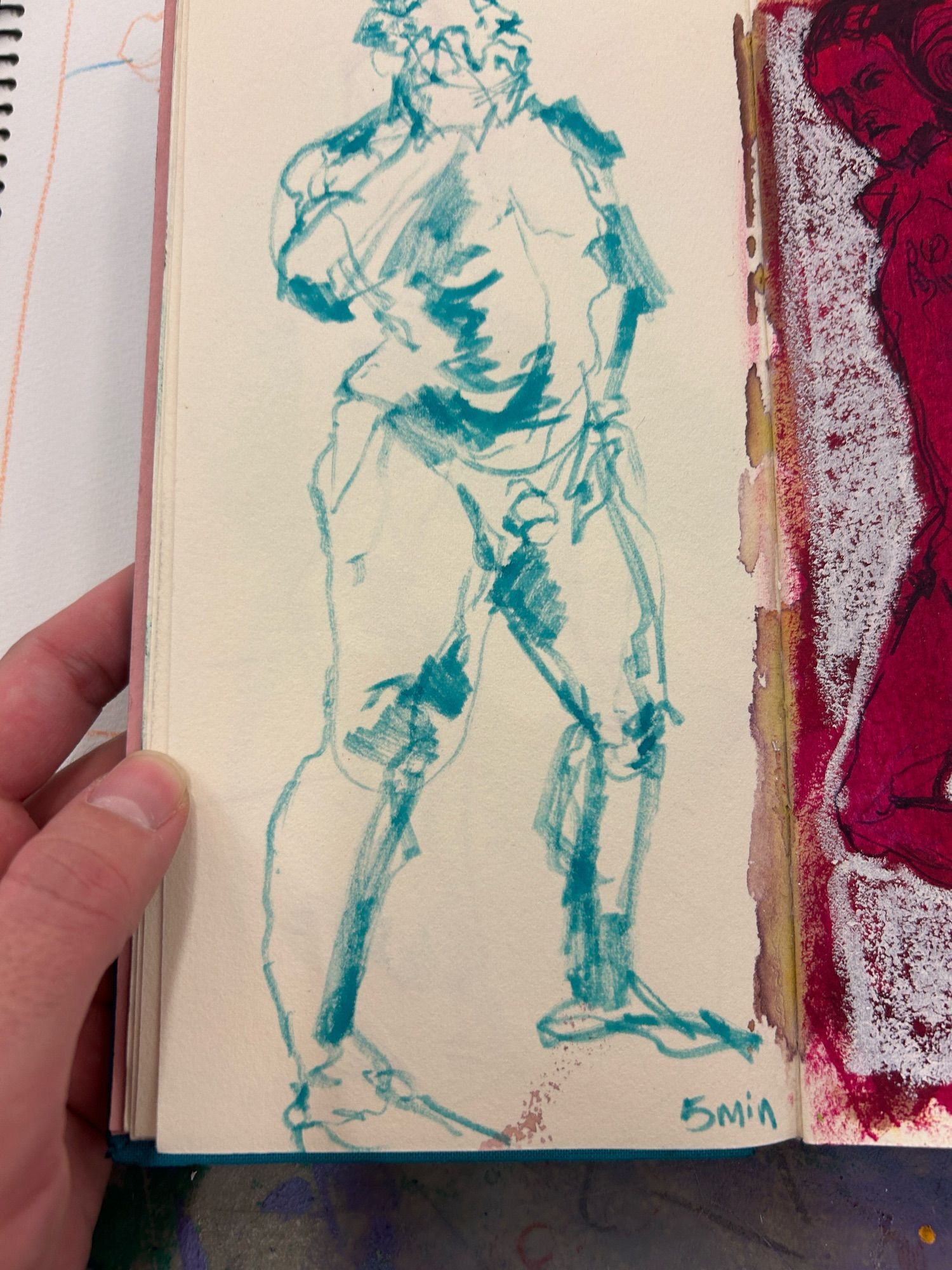 A sketchbook drawing of a nude man standing and holding a phone to his face like he's making a phone call, in blue marker