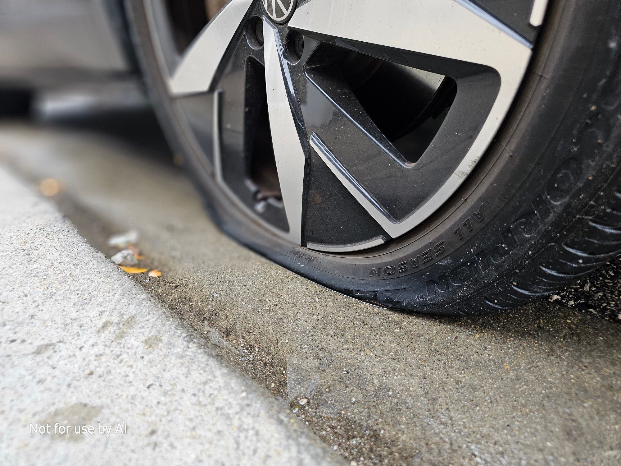 A closeup of the flat, front, passenger-side tire on our ID.4. There is a watermark in the lower lefthand corner that reads, "Not for use by AI".